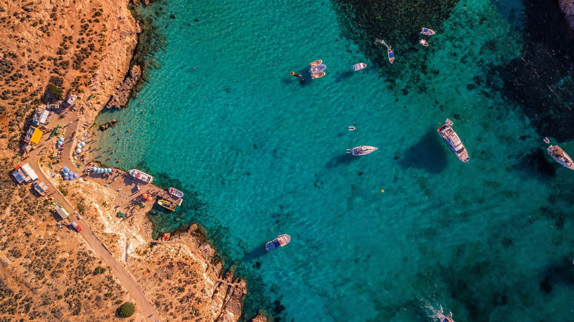 An aerial view of a small bay with boats in the water in Malta.