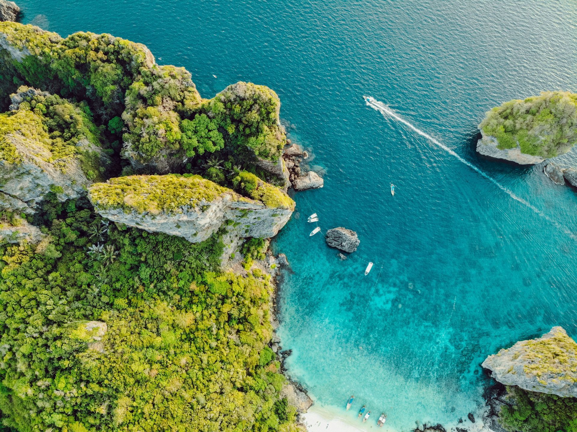 An aerial view of the Phi Phi Islands with boats in the water in Krabi, Thailand.