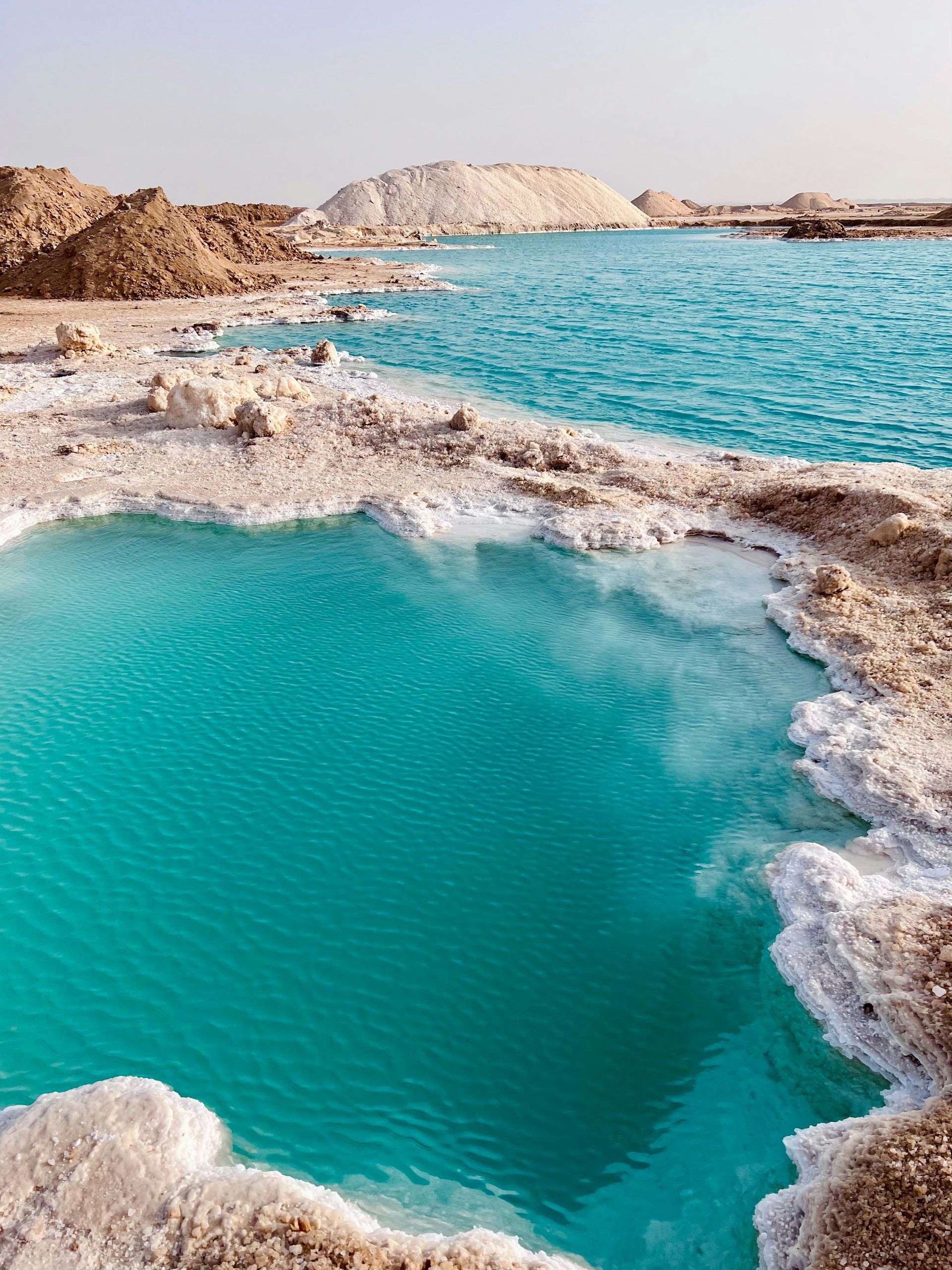A salt lake surrounded by rocks and salt at the Siwa Oasis, Egypt.