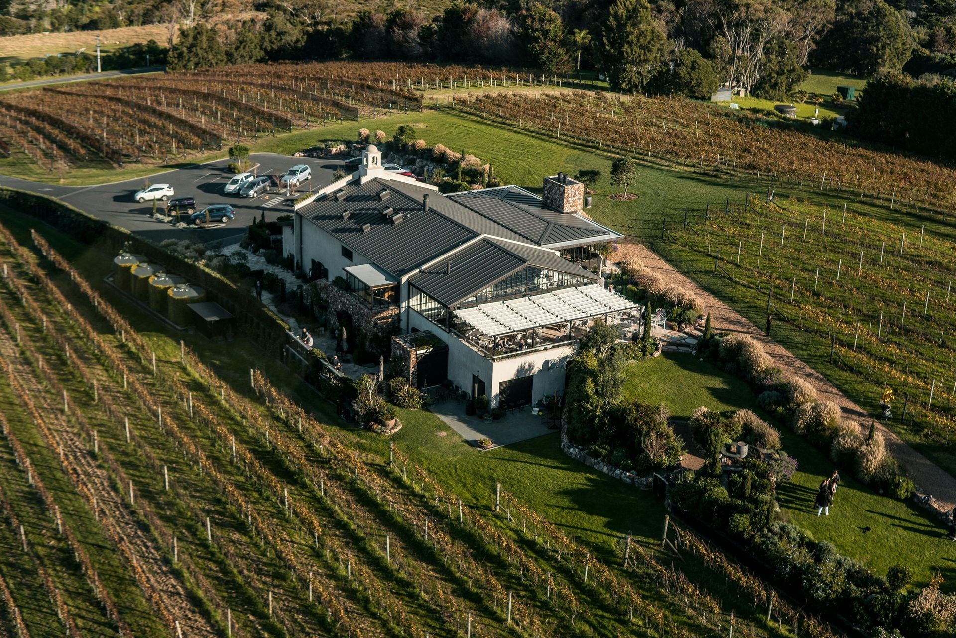 An aerial view of a large building in the middle of a vineyard on Waiheke Island, New Zealand.