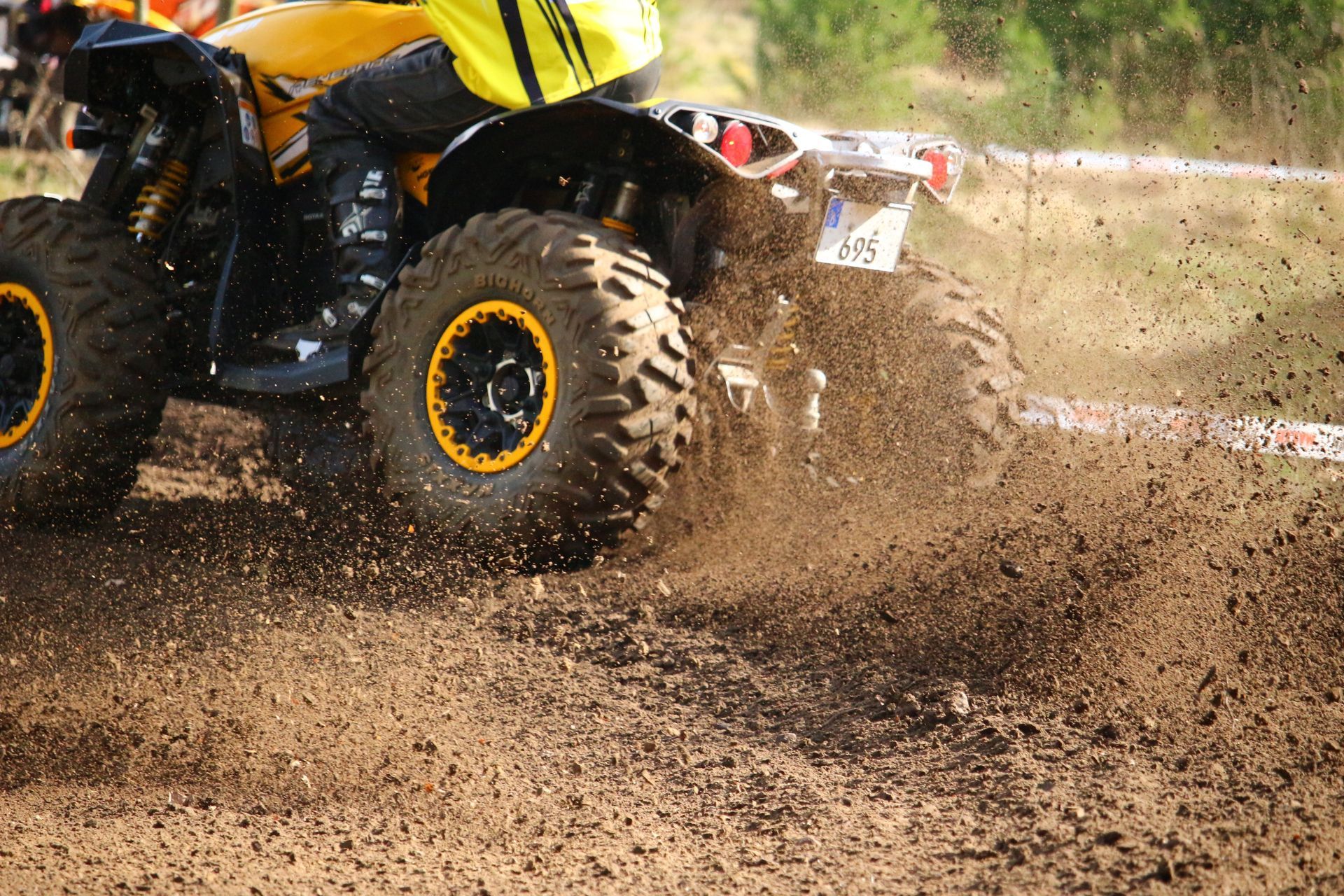 A person is riding an atv on a dirt road in Cancun.