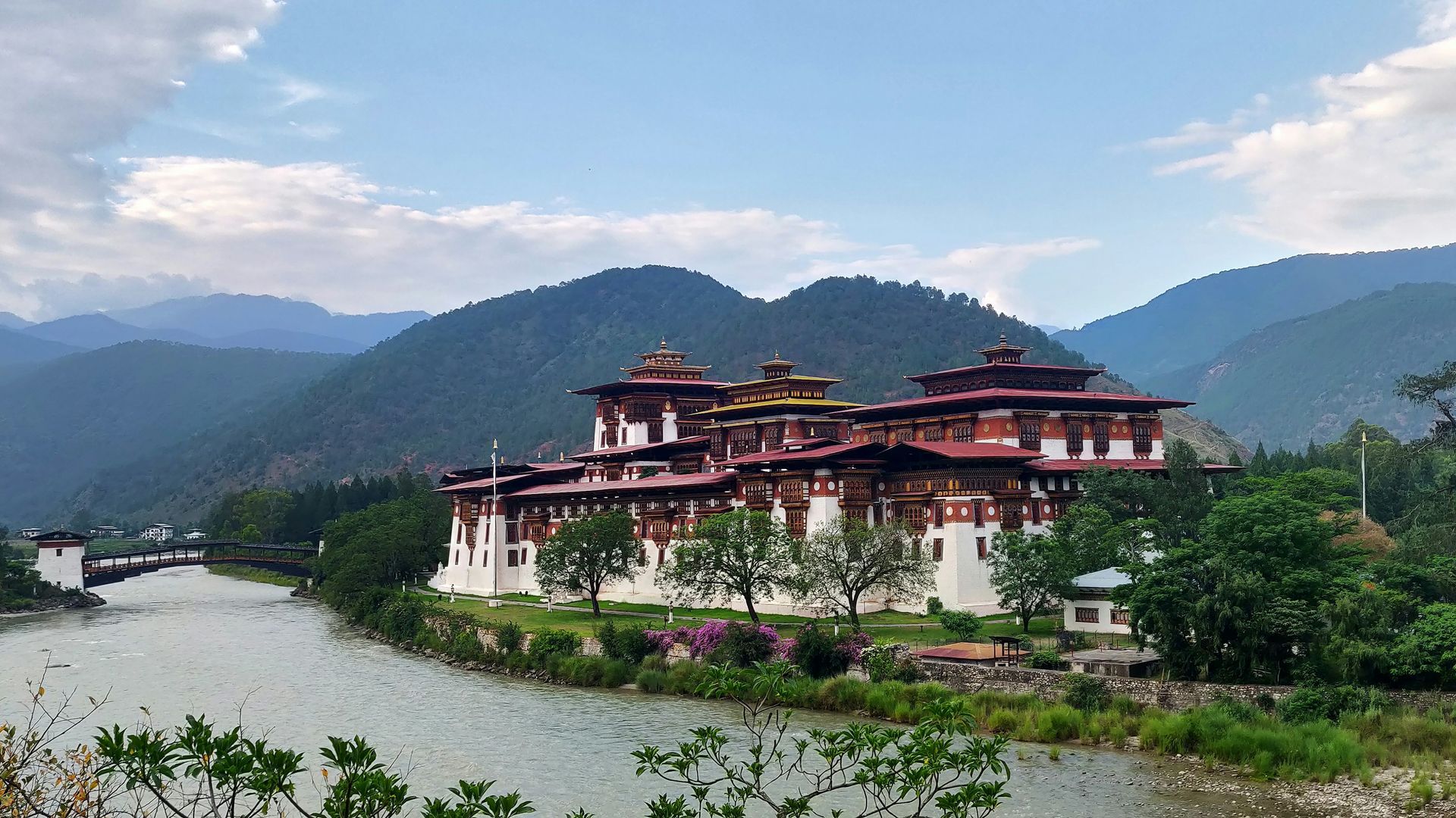 Punakha Dzong beside a river, with mountains in the background in Punakha, Bhutan.
