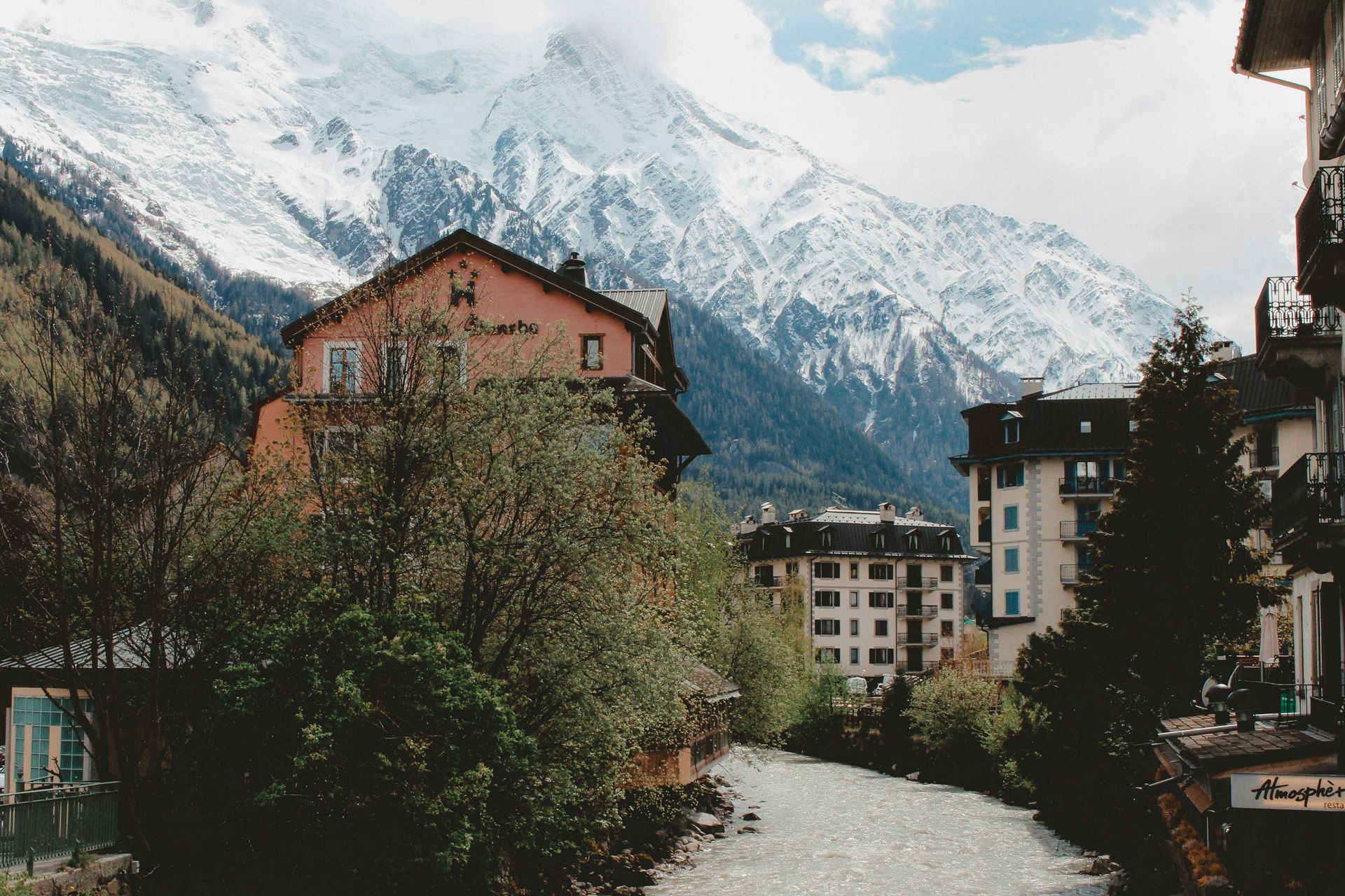 A river runs through Chamonix, France with mountains in the background.