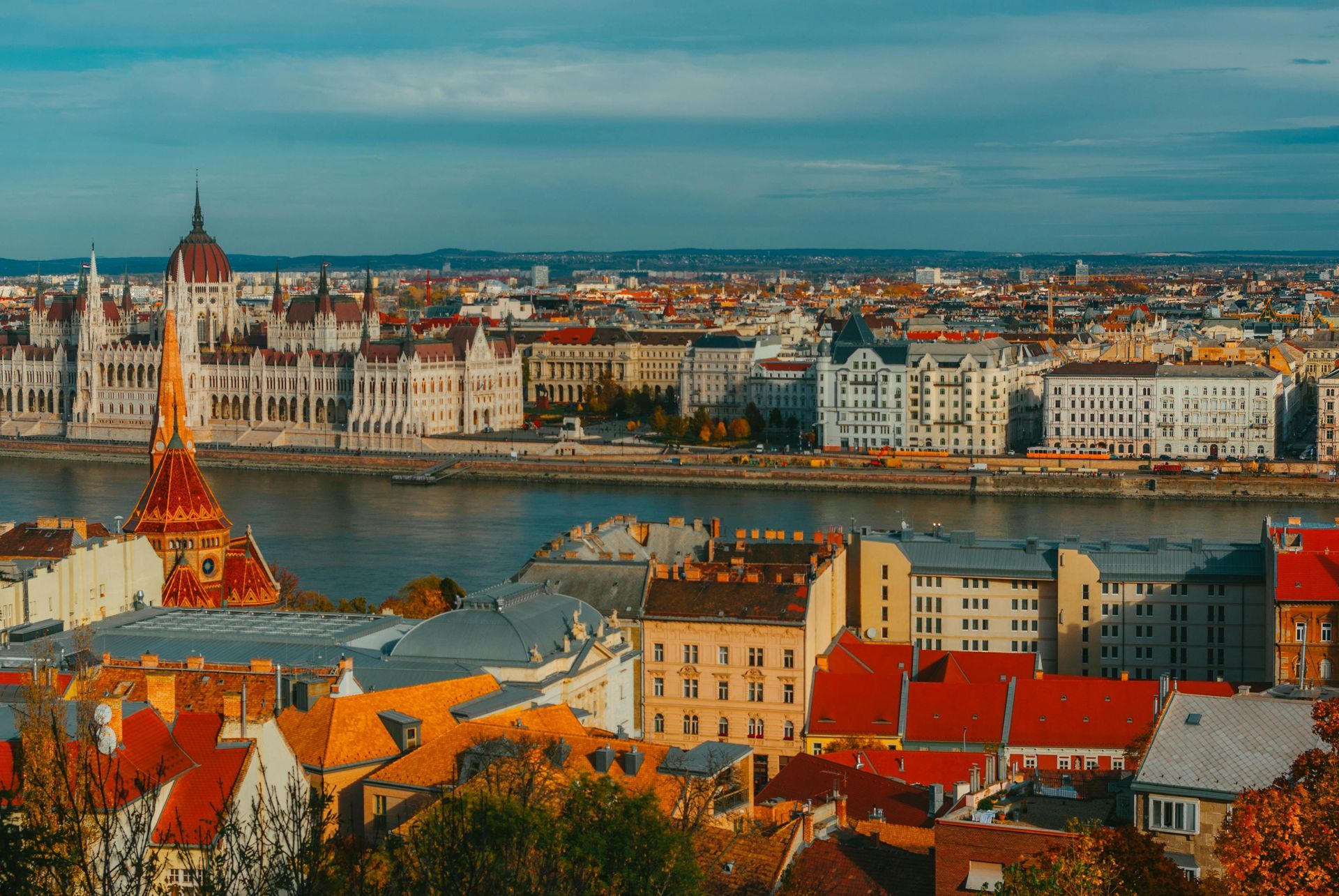 An aerial view of a city and The Danube River in the background.