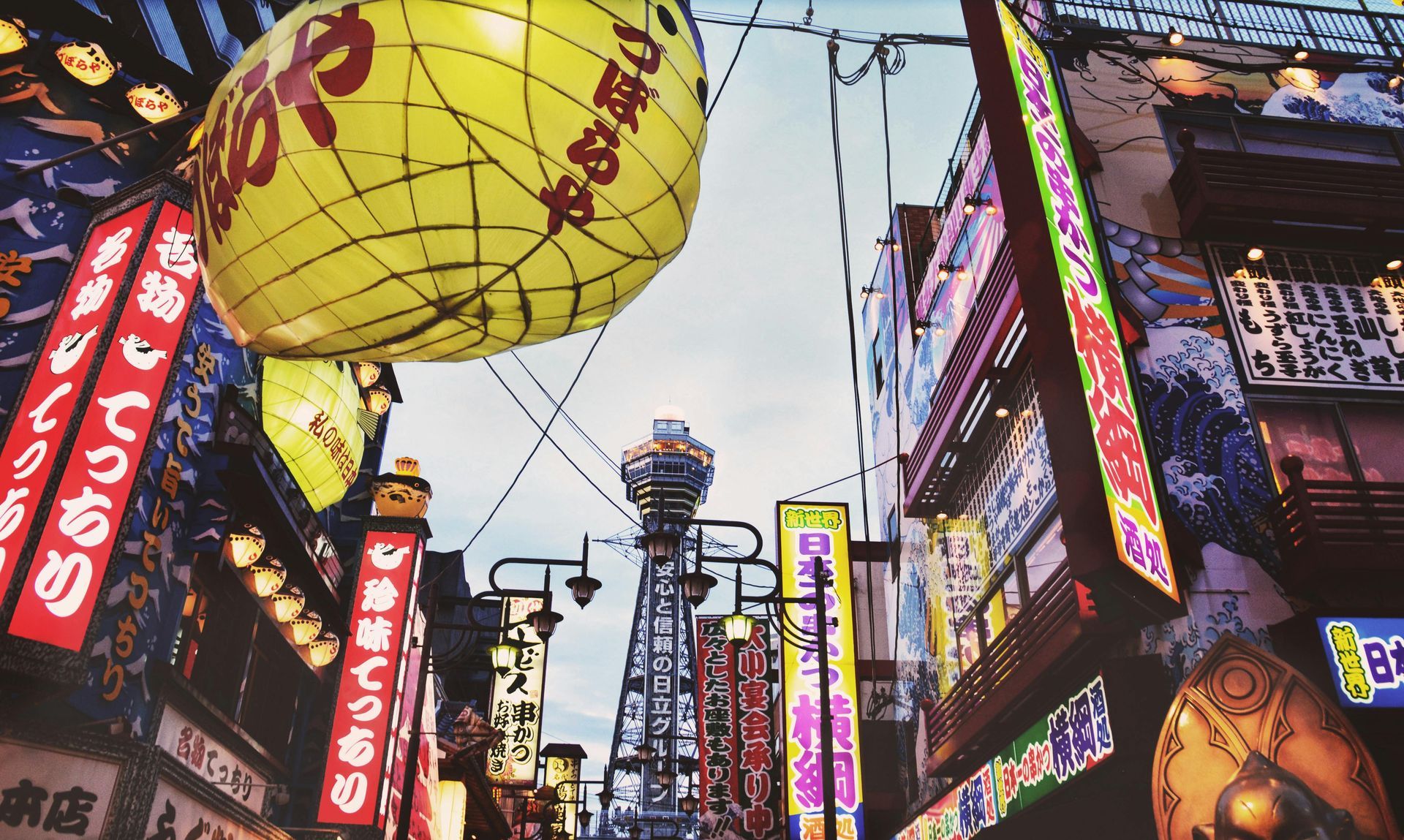 A city street with japanese writing on the signs in Japan. 