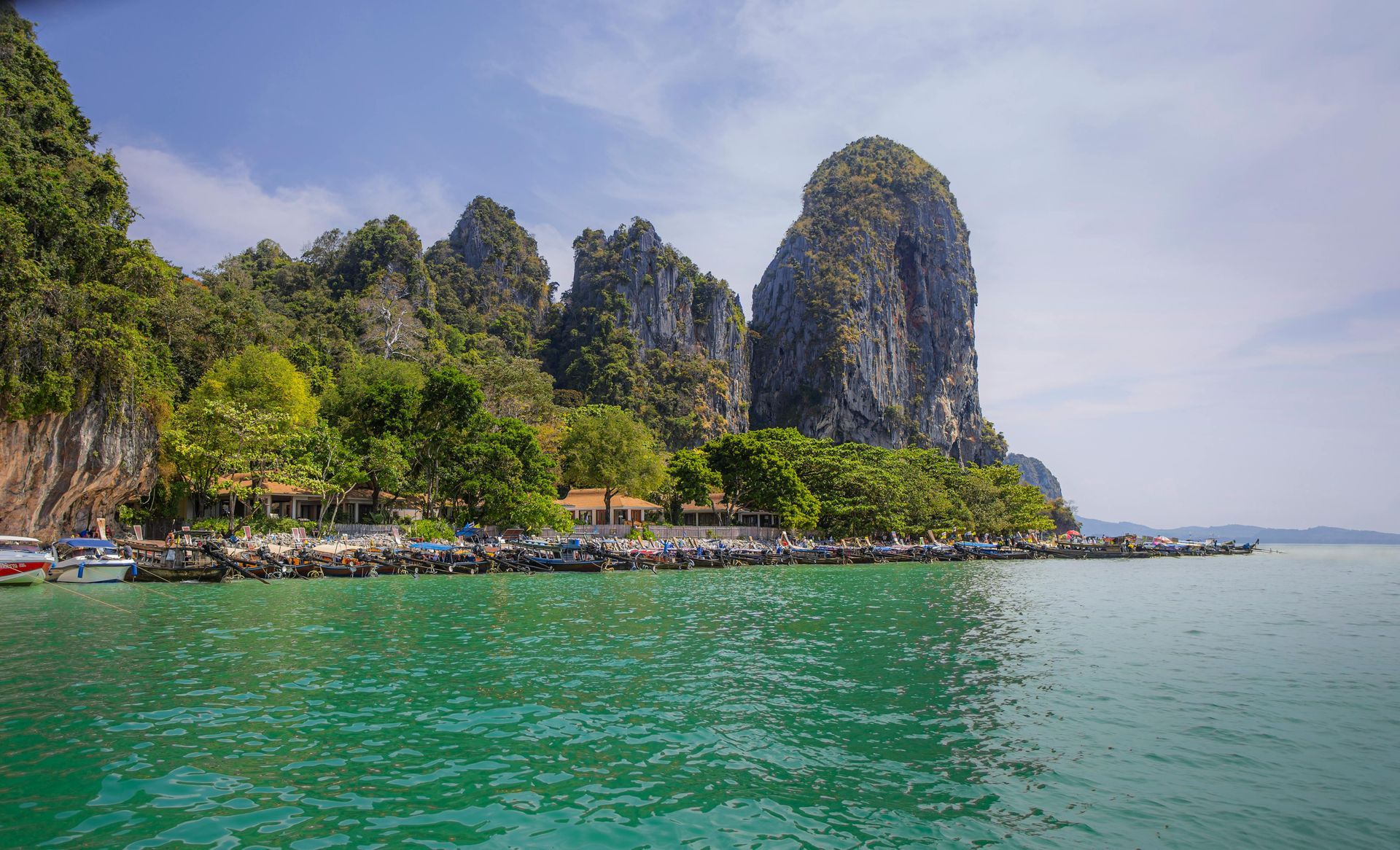 A large body of water with a mountain in the background at Railay Beach in Thailand. 