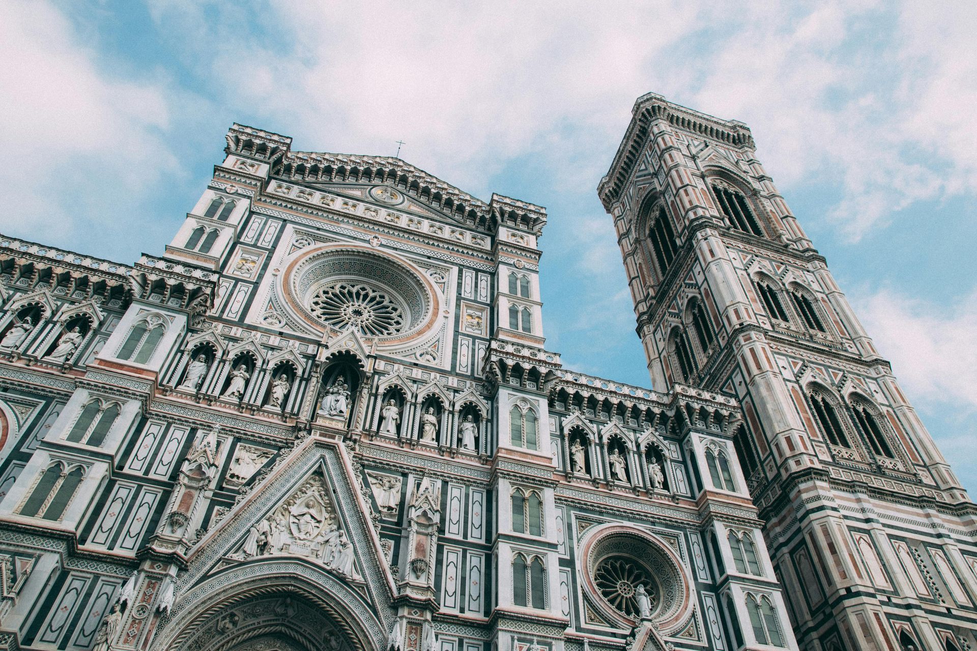 A large building with a clock tower on top of it in Florence, Italy.