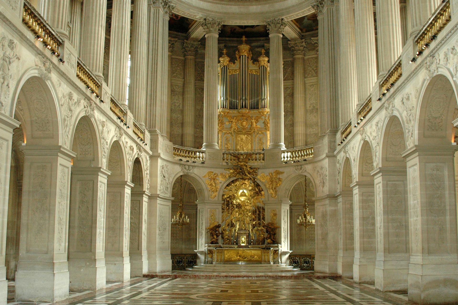 The inside of a large building with columns and arches in northern France. 