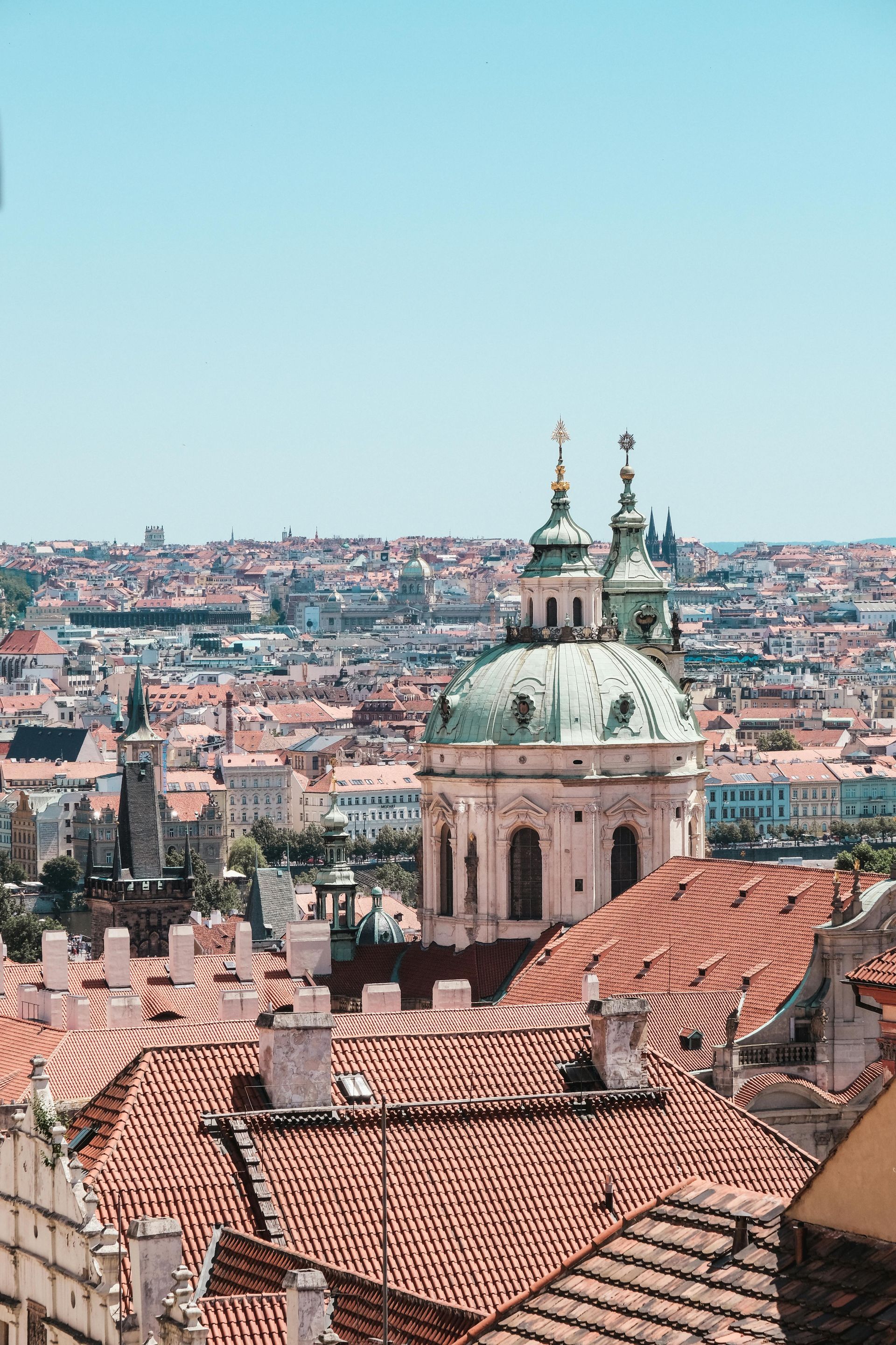 An aerial view of Prague with a dome on top of a building.