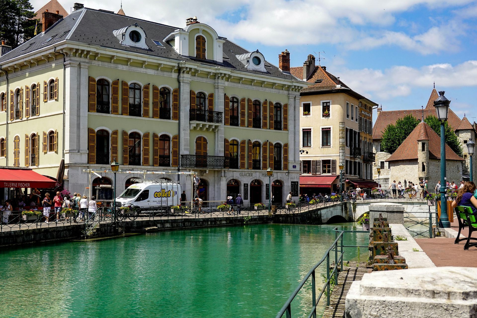 A large building is next to a body of water in Annecy, France.