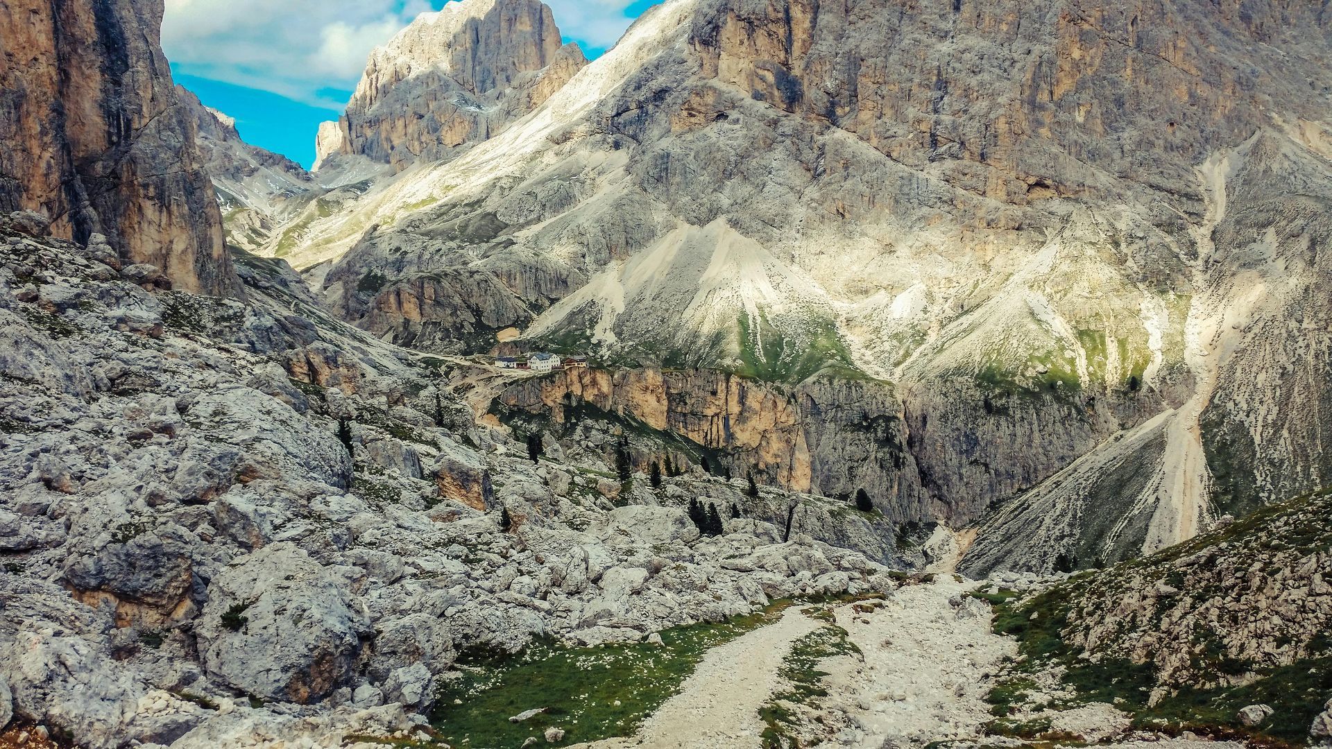 The Dolomites landscape with a lot of rocks and grass in Italy.