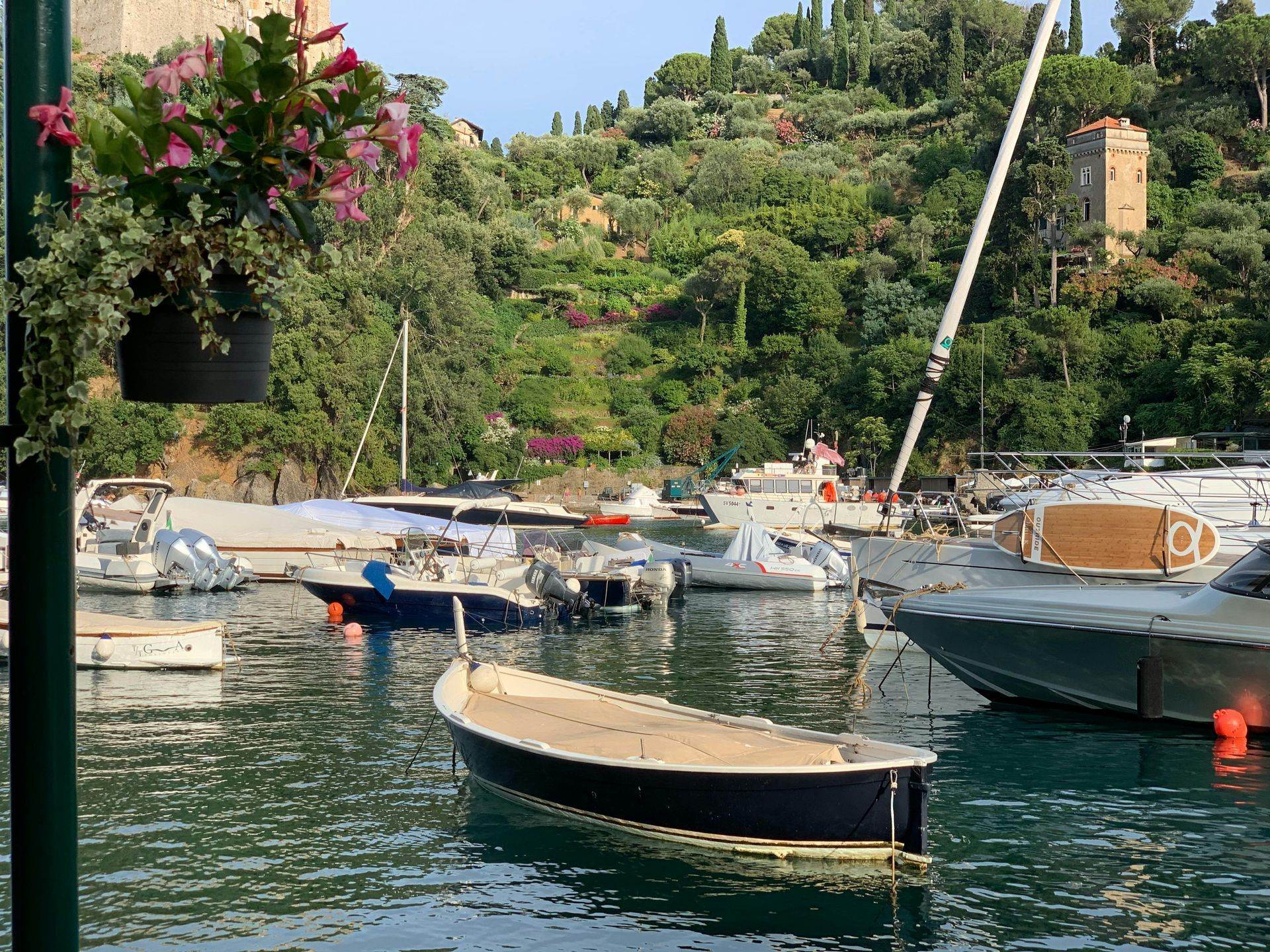 A row of boats are docked in a harbor in Portofino, Italy.