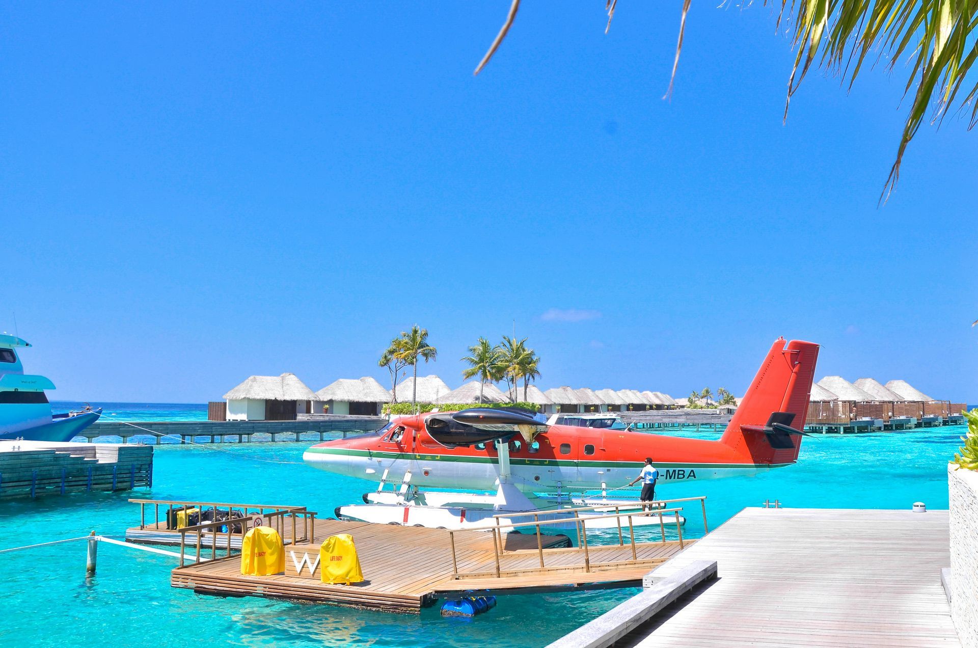 A seaplane is docked at a dock in the middle of the ocean in the Caribbean.