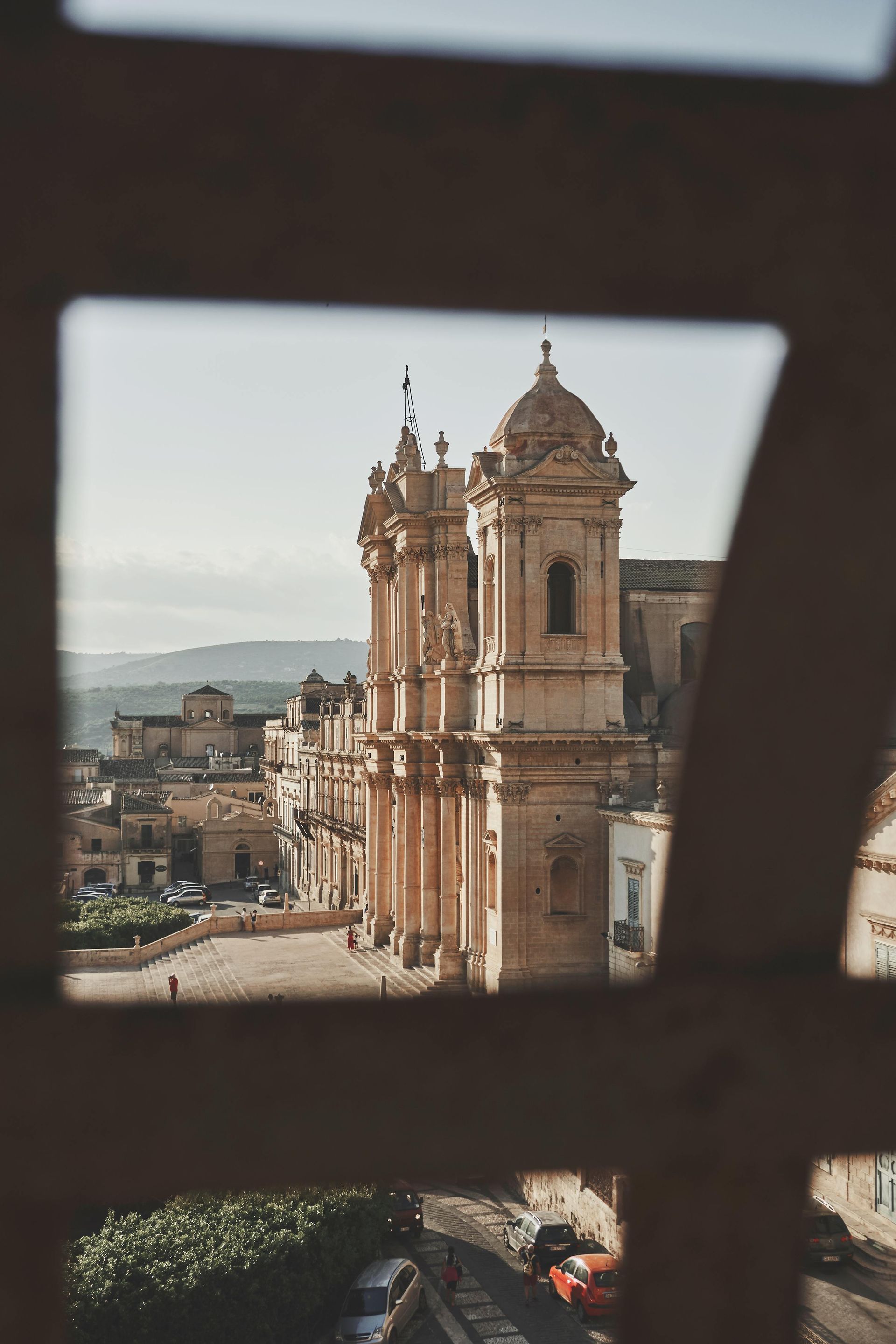 A view of a church through a wooden frame in Sicily, Italy.