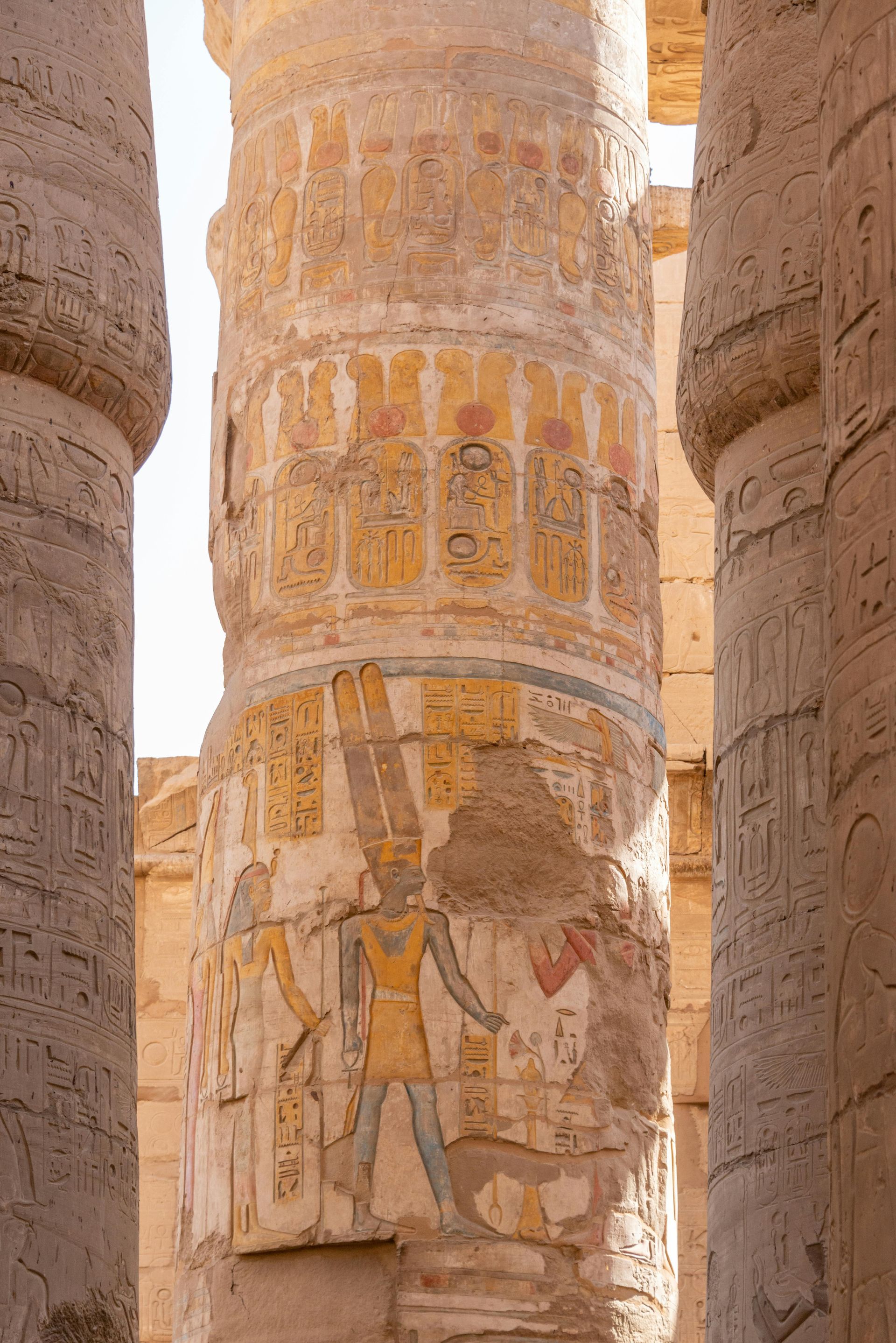 A close up of a pillar with a painting on it in Egypt.