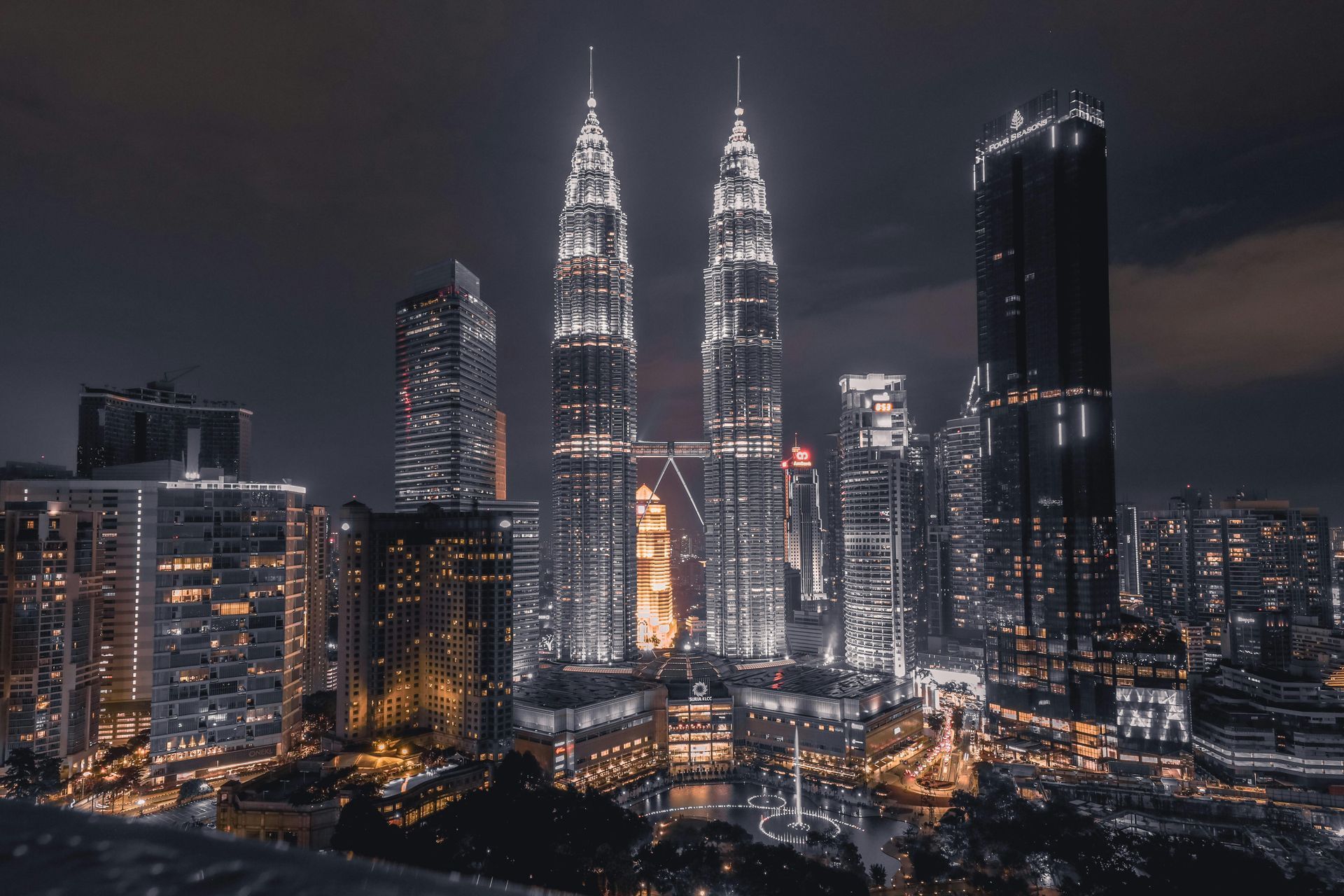 A city skyline at night with a lot of tall buildings in Malaysia.