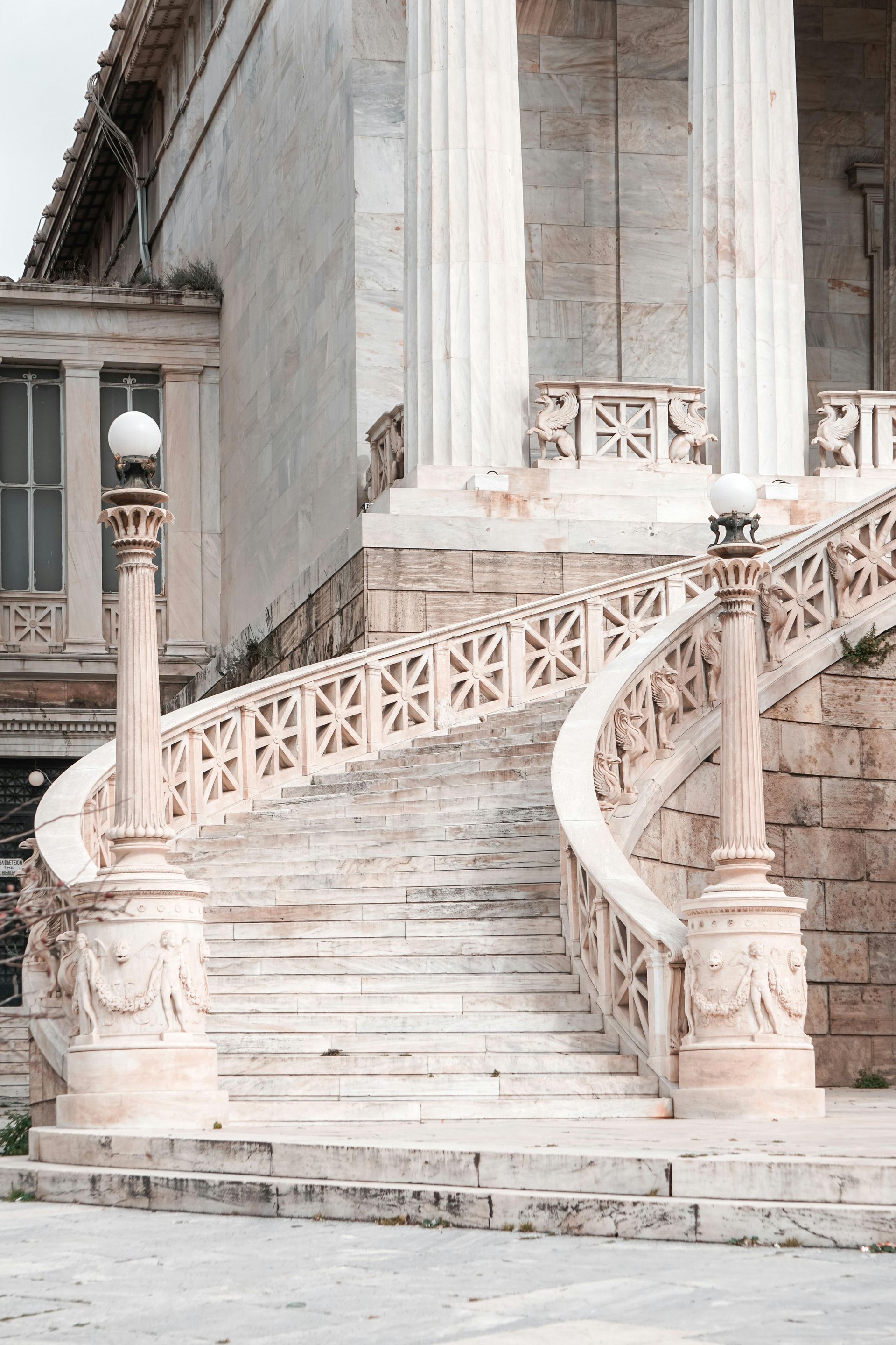 A set of stairs leading up to a building with columns in Athens, Greece.