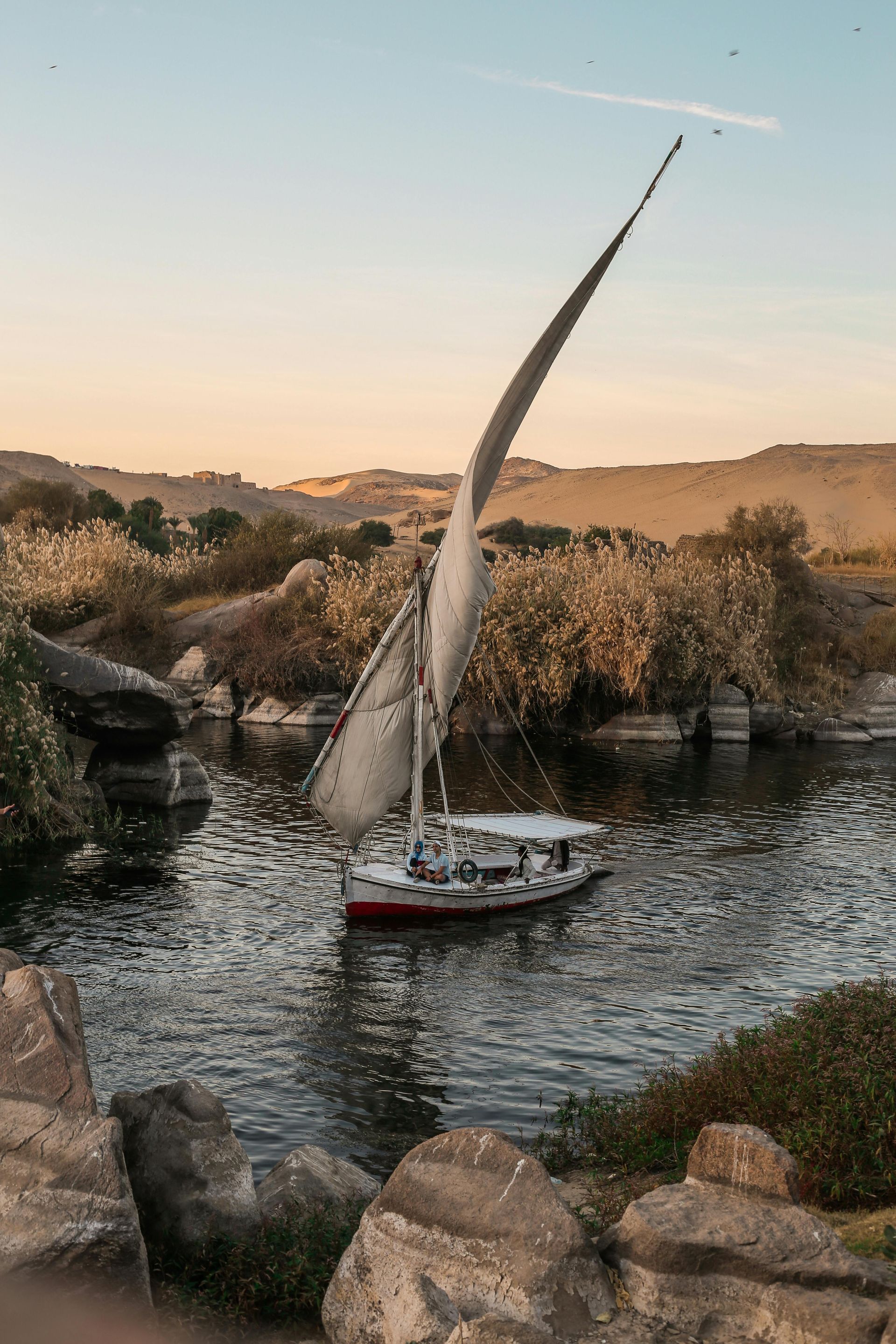 A sailboat is floating on top of the nile river in Egypt.