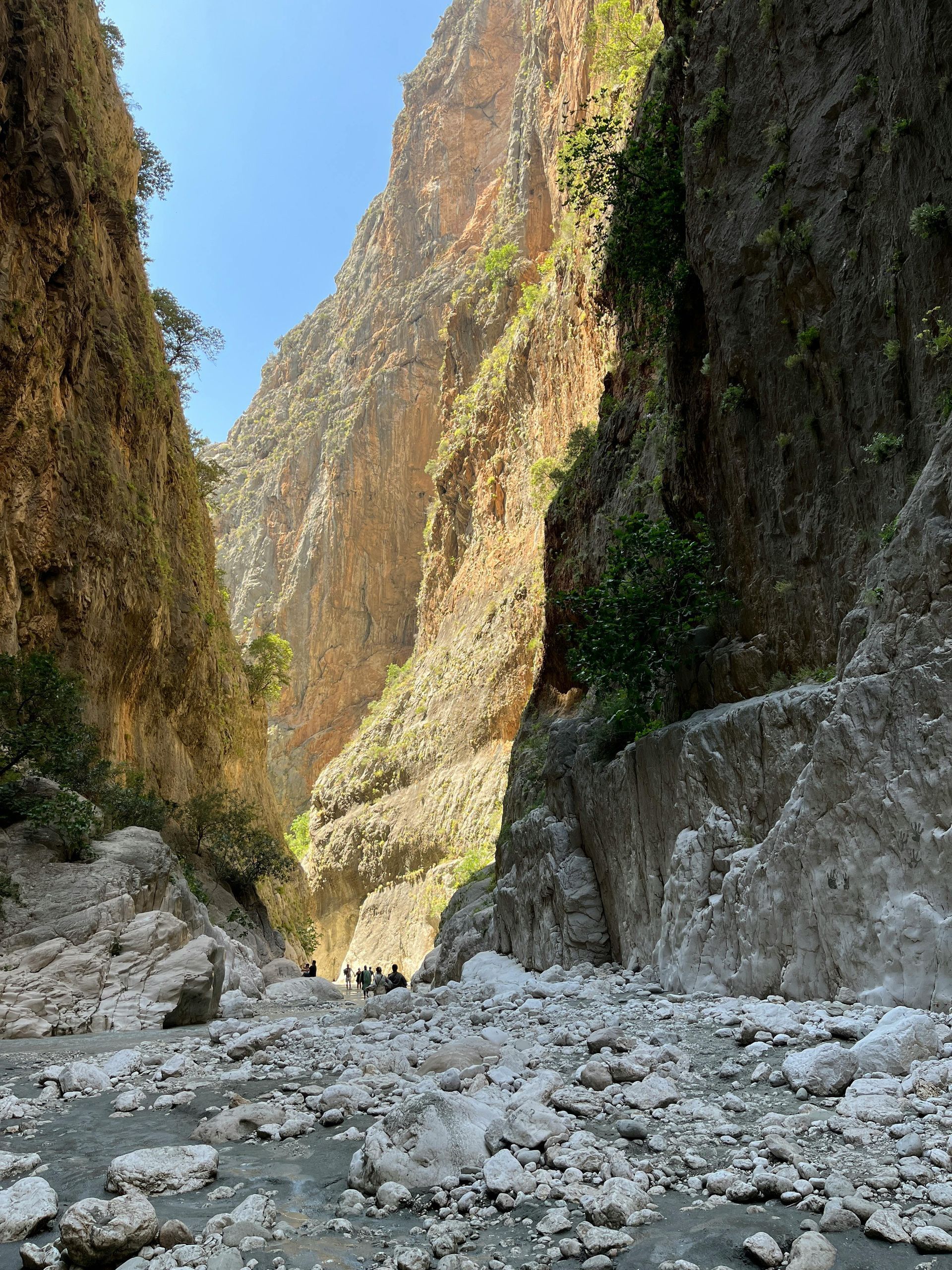 A river runs through a canyon between two mountains in Crete, Greece.