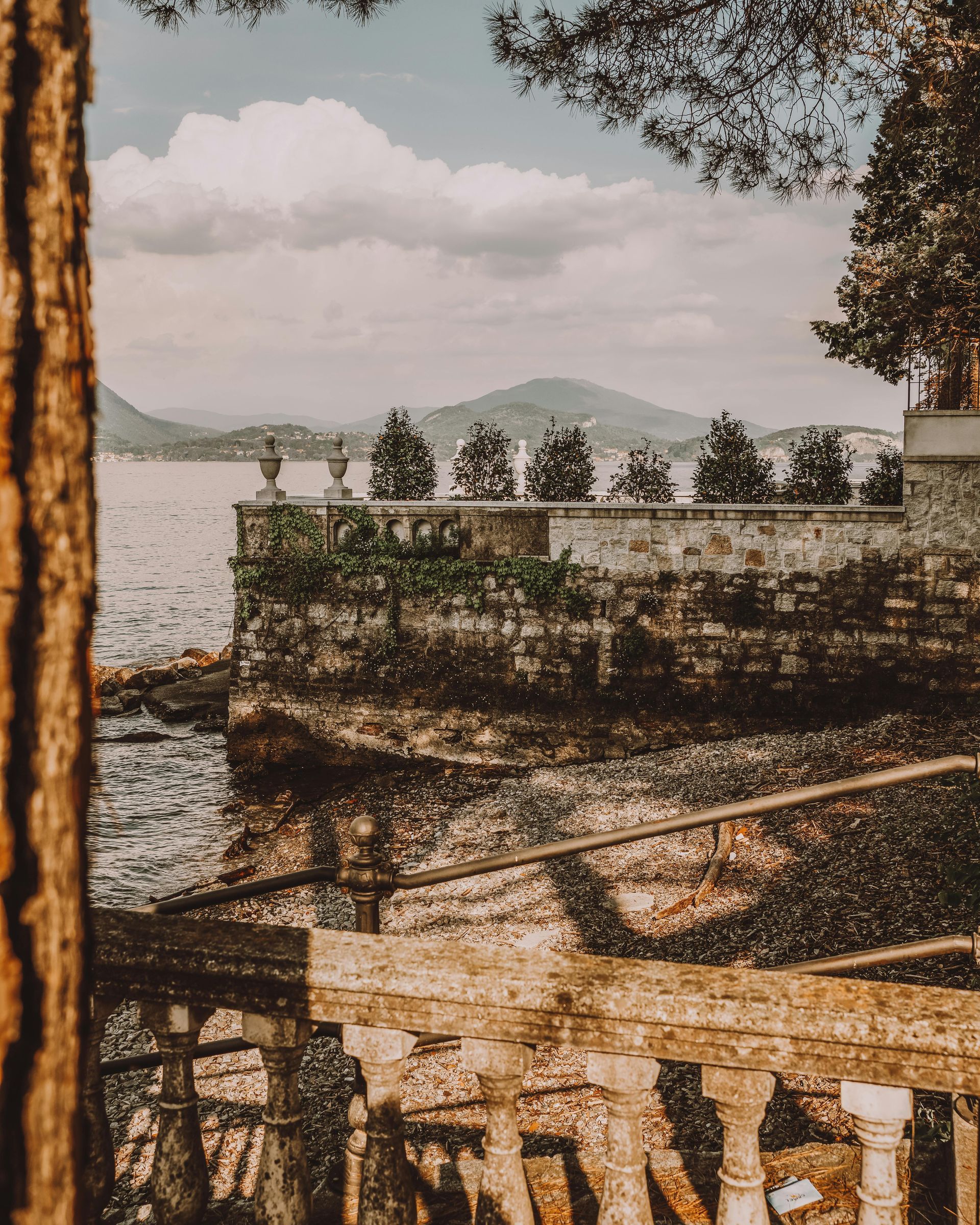 A view of Lake Como through a stone fence in Italy.