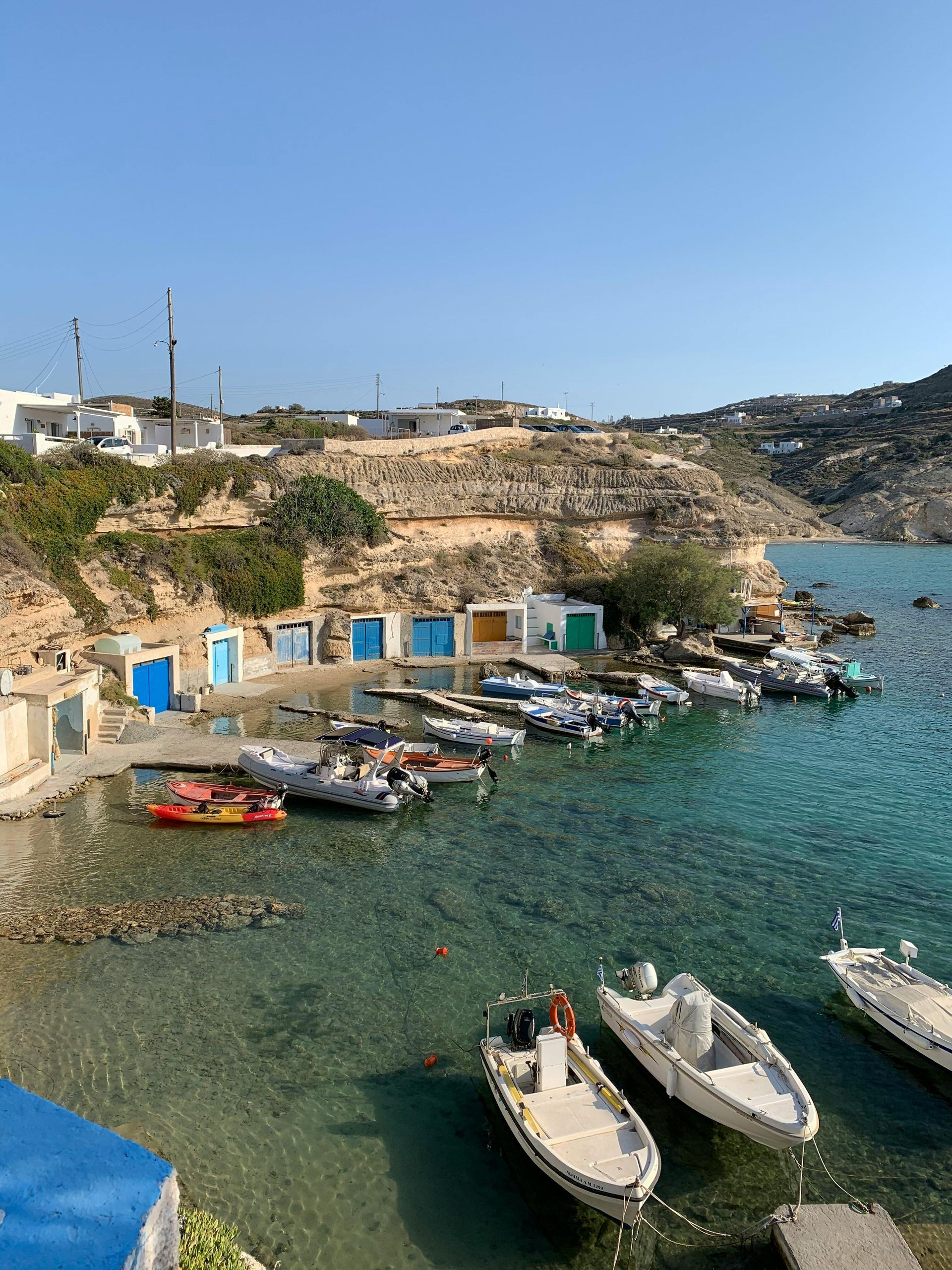 A row of boats are docked at the fishing village of Mandrakia in Milos, Greece.