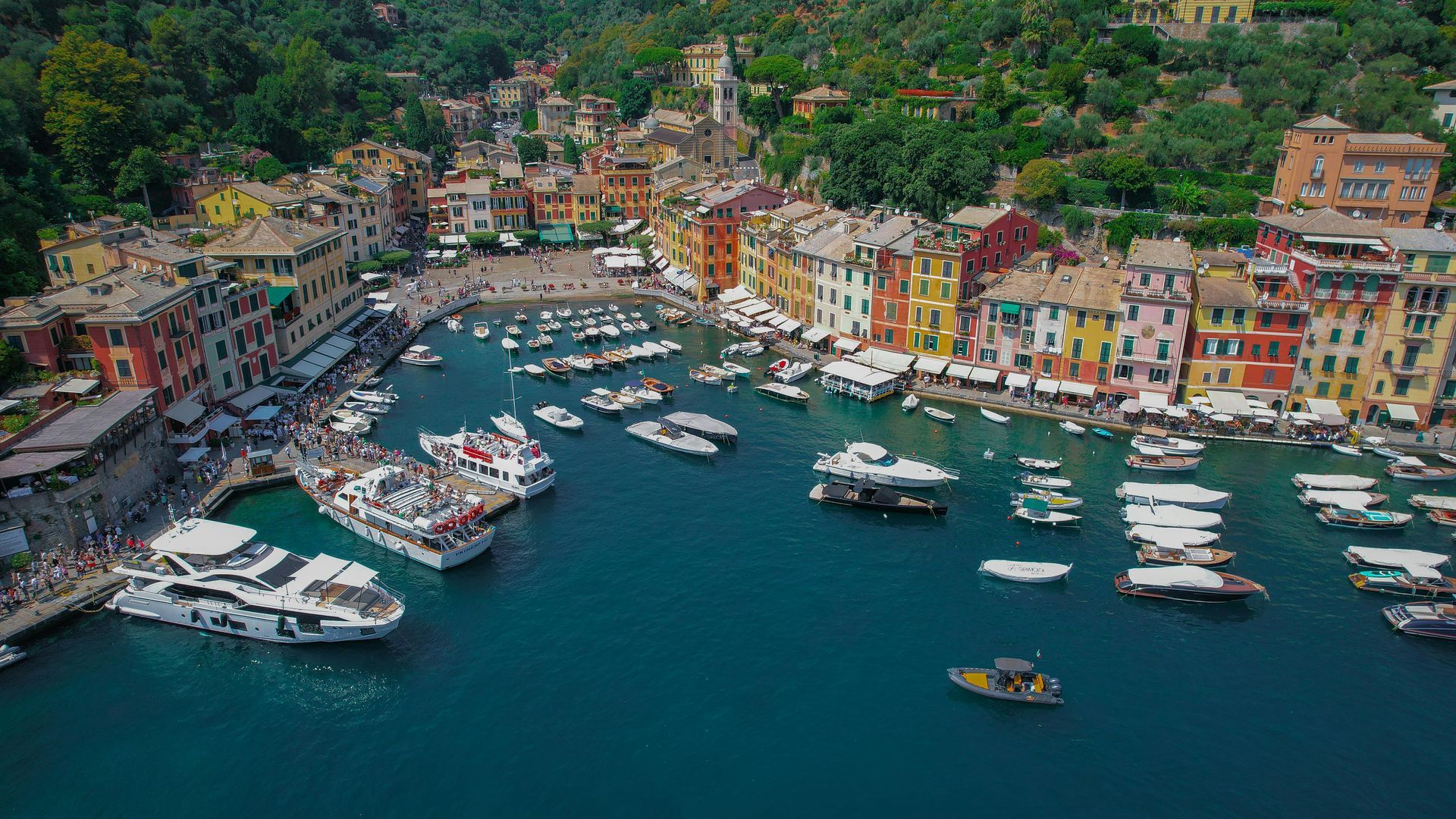 An aerial view of a harbor filled with boats and buildings in Portofino, Italy.