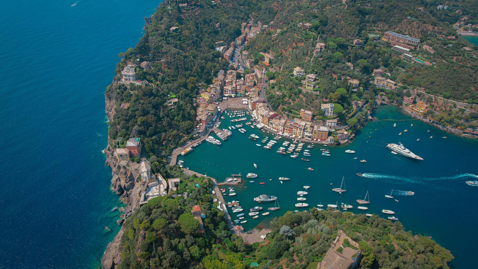 An aerial view of Portofino, Italy in the middle of a large body of water.