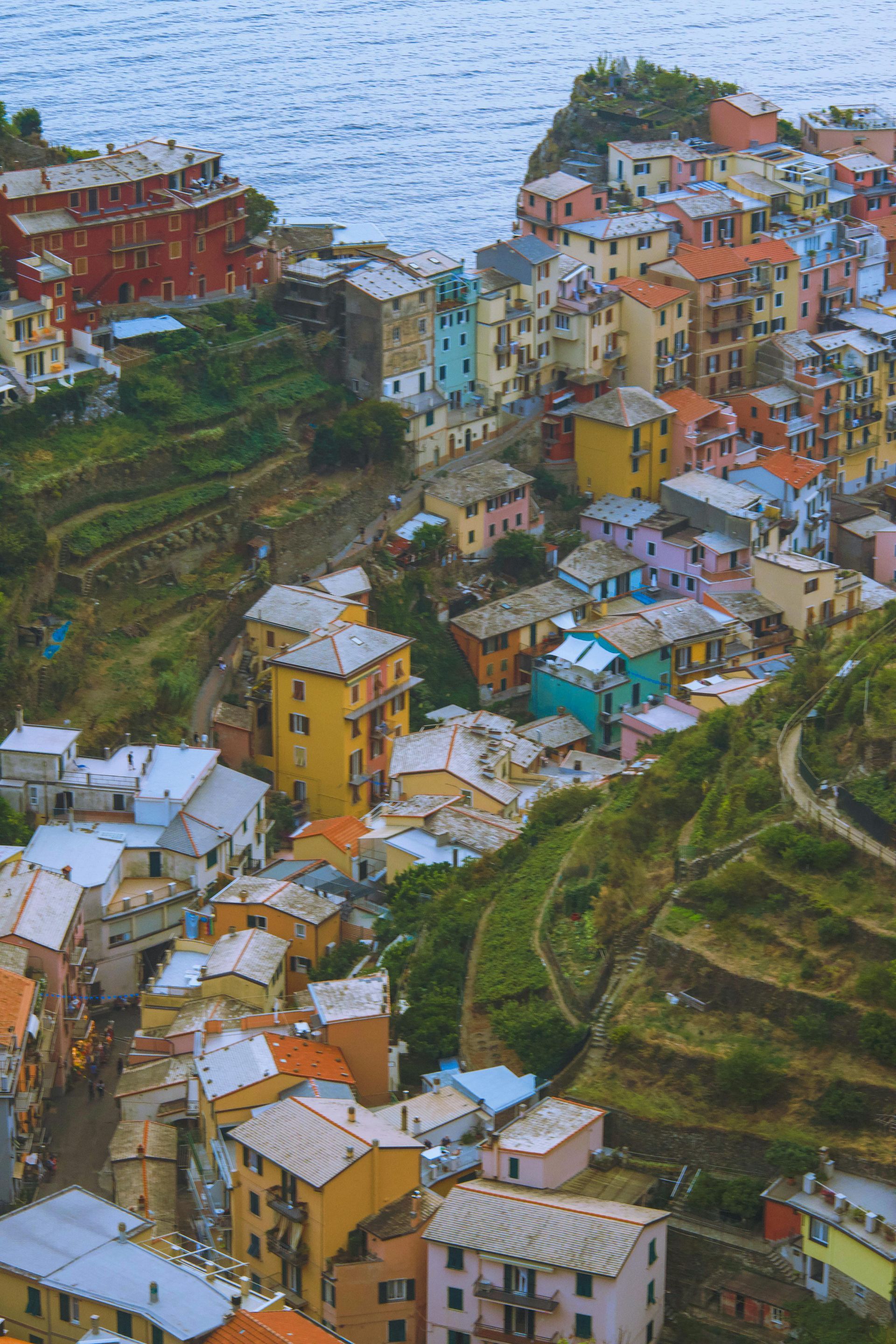 An aerial view of Cinque Terre on a hill next to the ocean in Italy.