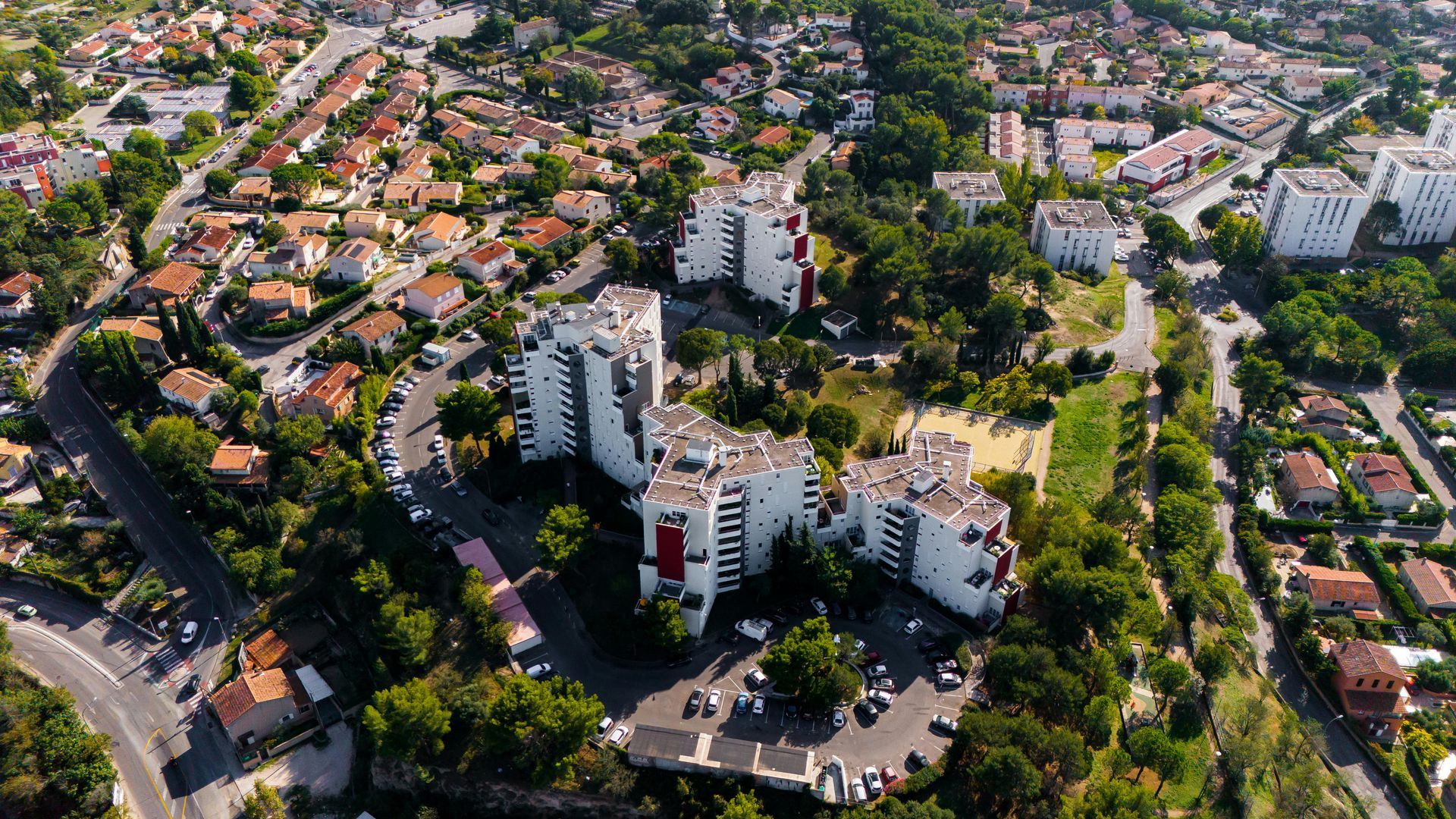 An aerial view of a city with a lot of buildings and trees in Aix-en-Provence.