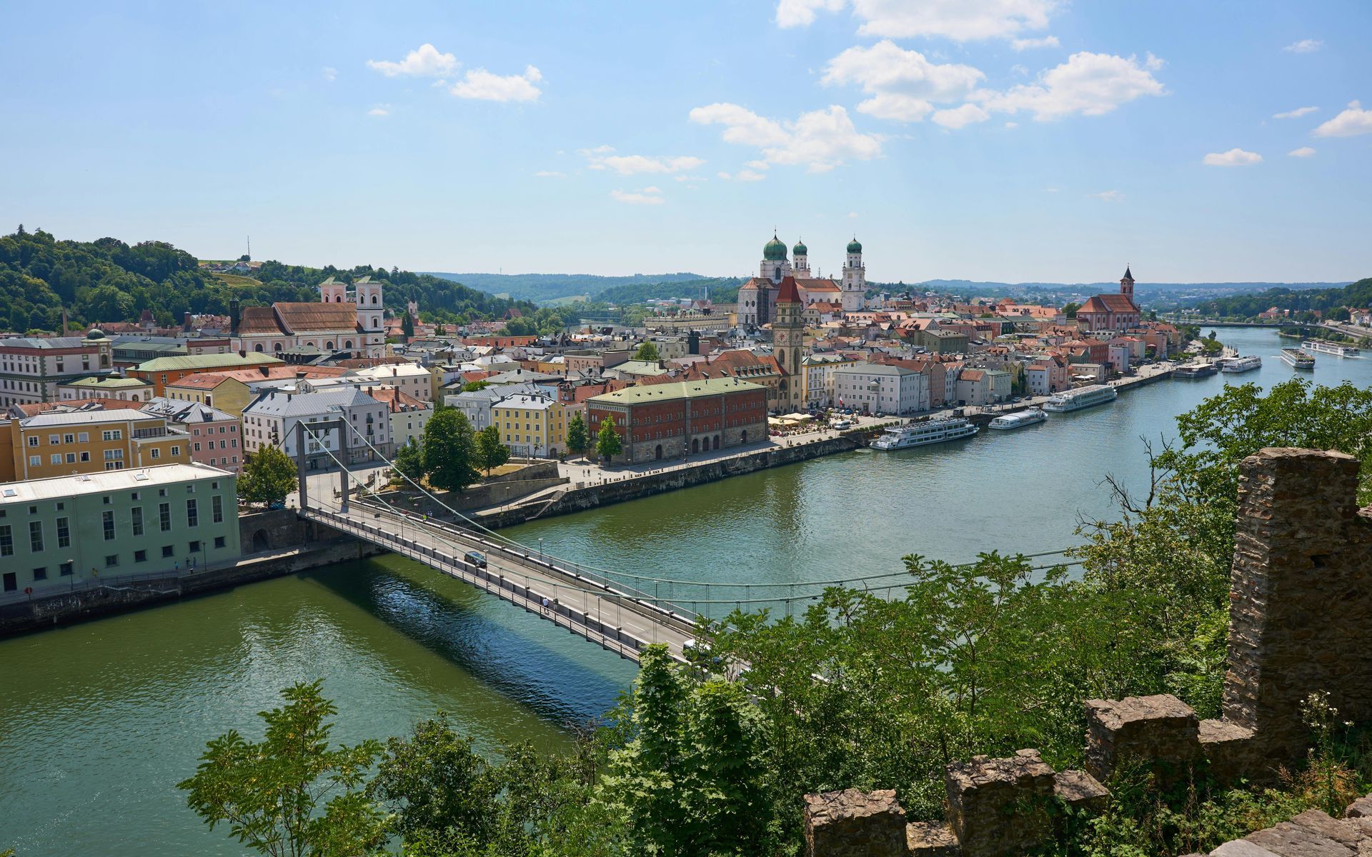 An aerial view of a city with a European bridge over The Danube River.