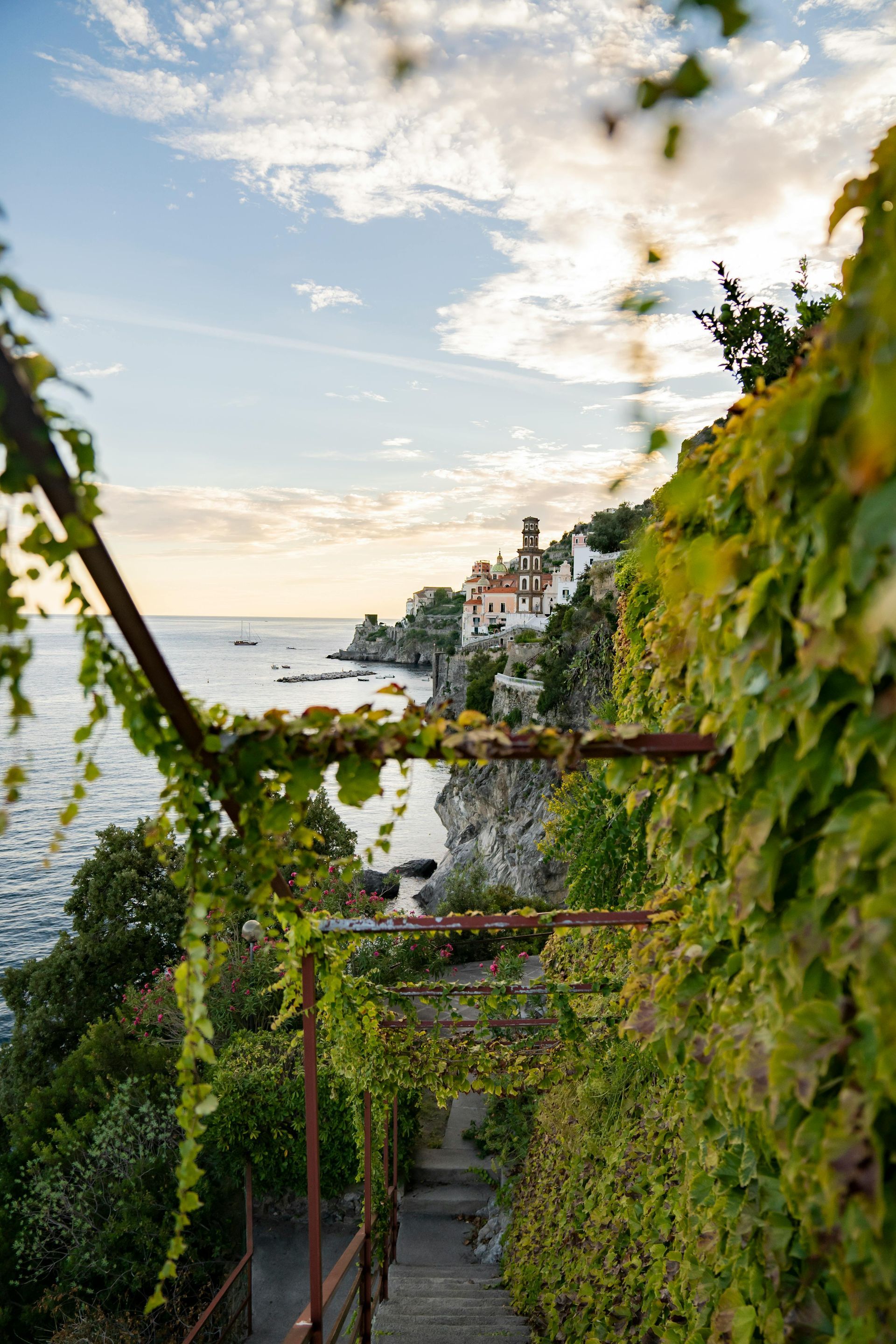 A staircase leading up to a cliff overlooking the ocean in the Amalfi Coast, Italy.