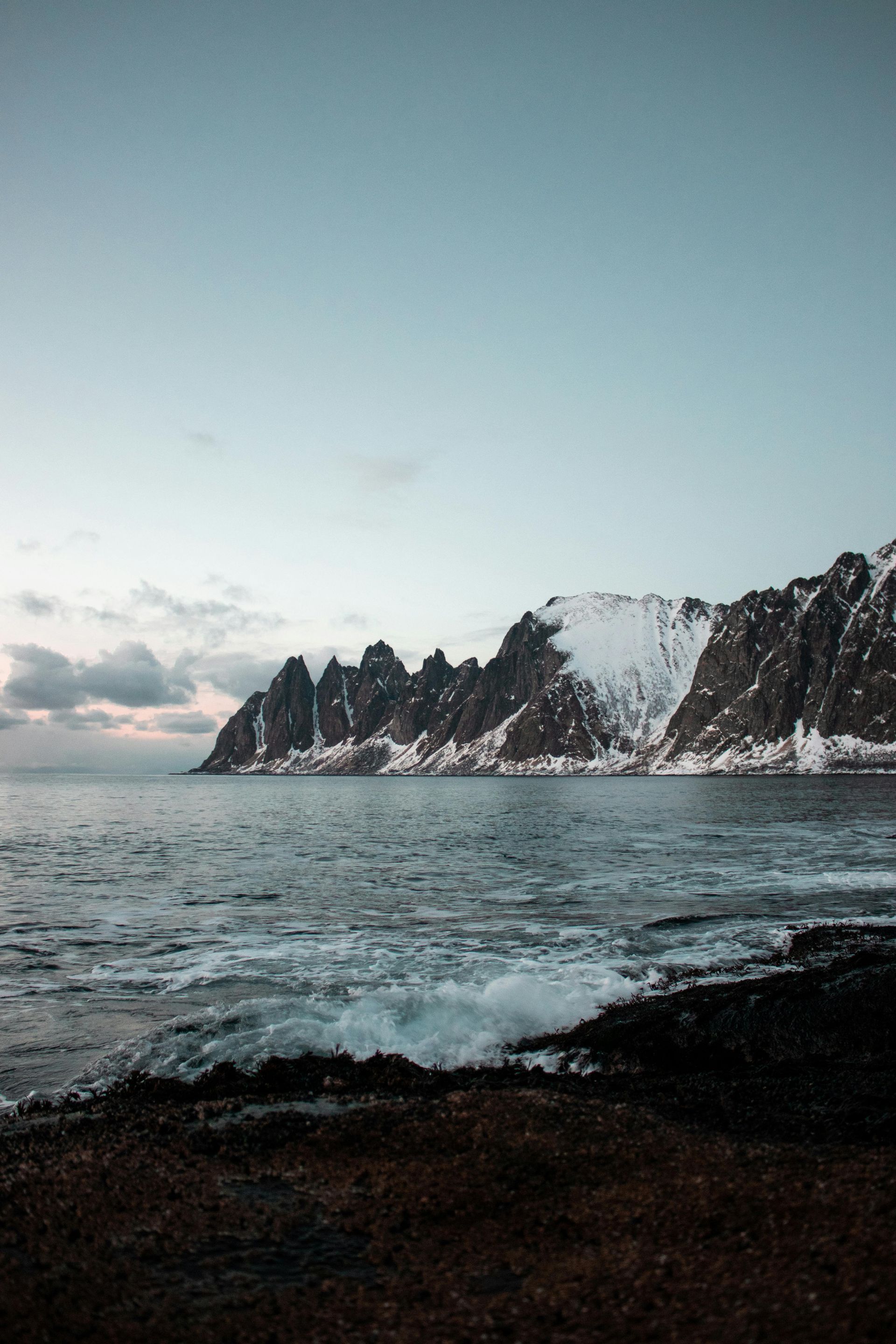 A large body of water with mountains in the background on the Norwegian Coast.