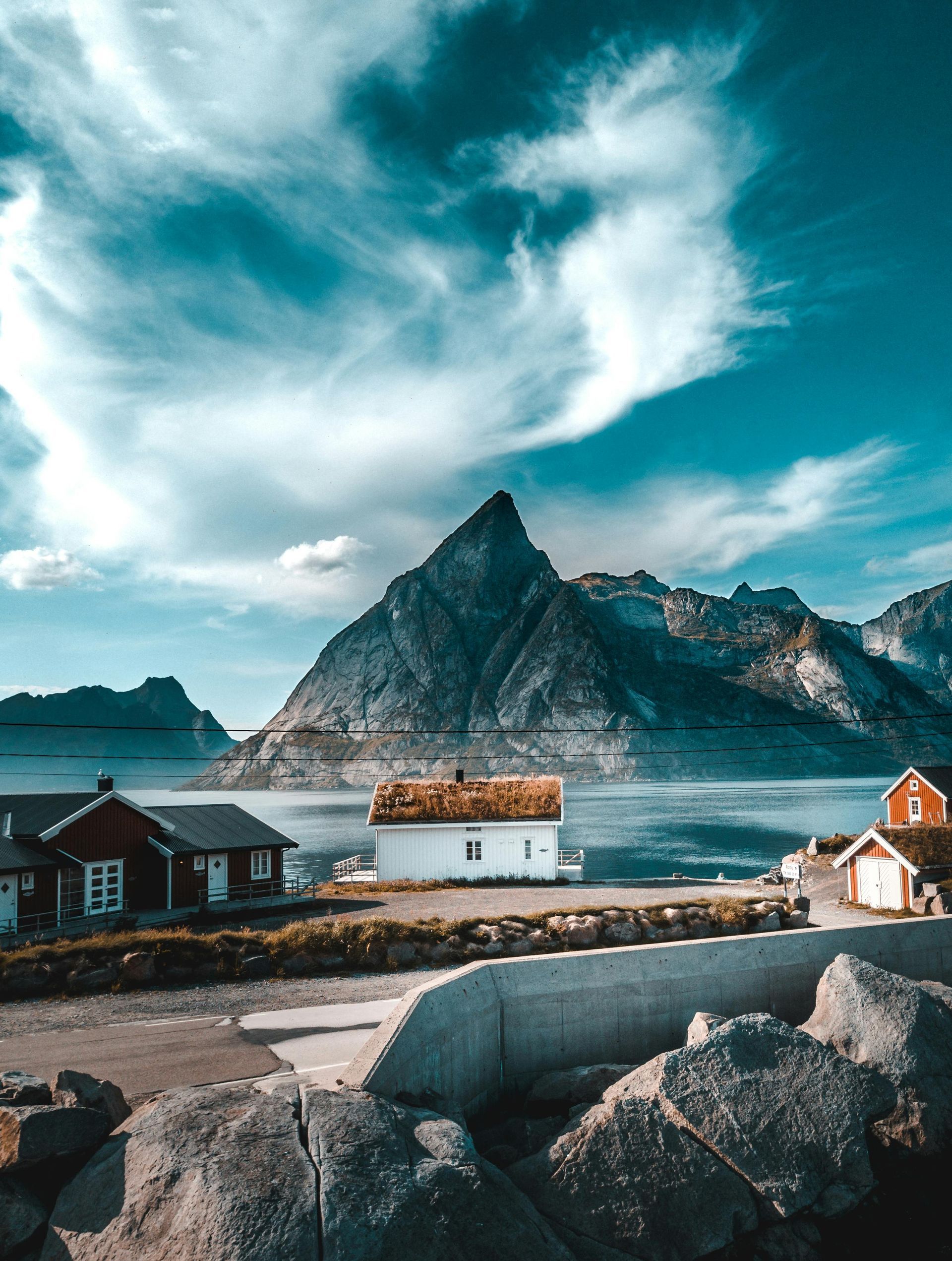 A small village with a mountain in the background and a house in the foreground in Norway.