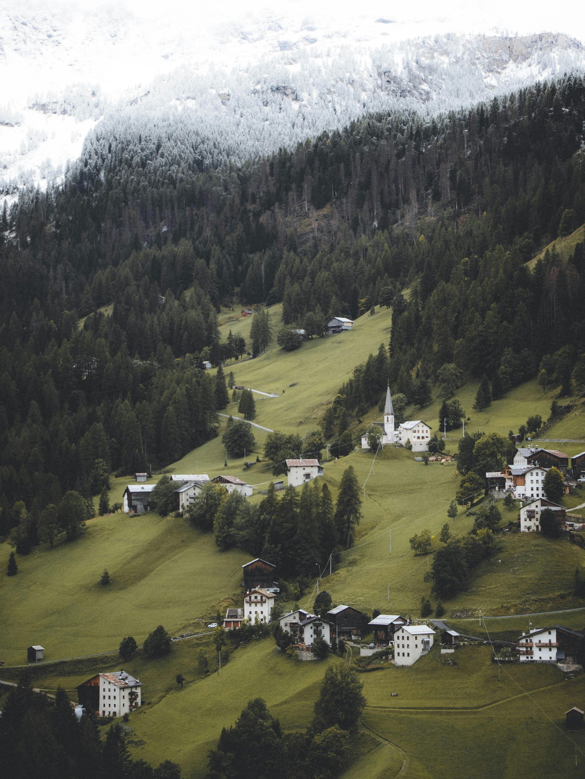 An aerial view of a small village in the mountains in The Dolomites in Italy.