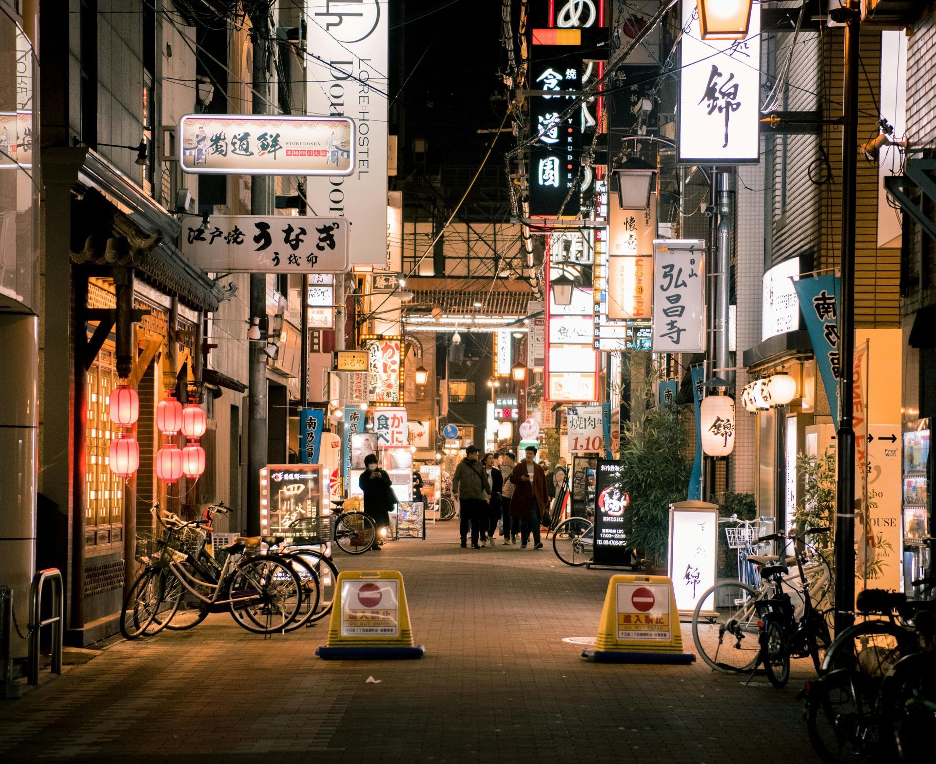 A narrow street with a sign that says no entry in Japan.