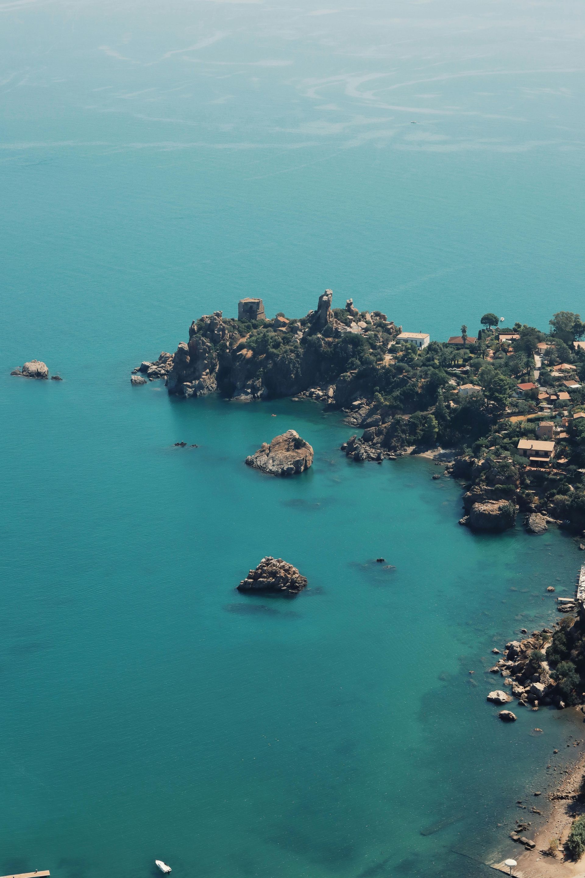 An aerial view of a small island in the middle of the ocean in Sicily, Italy.