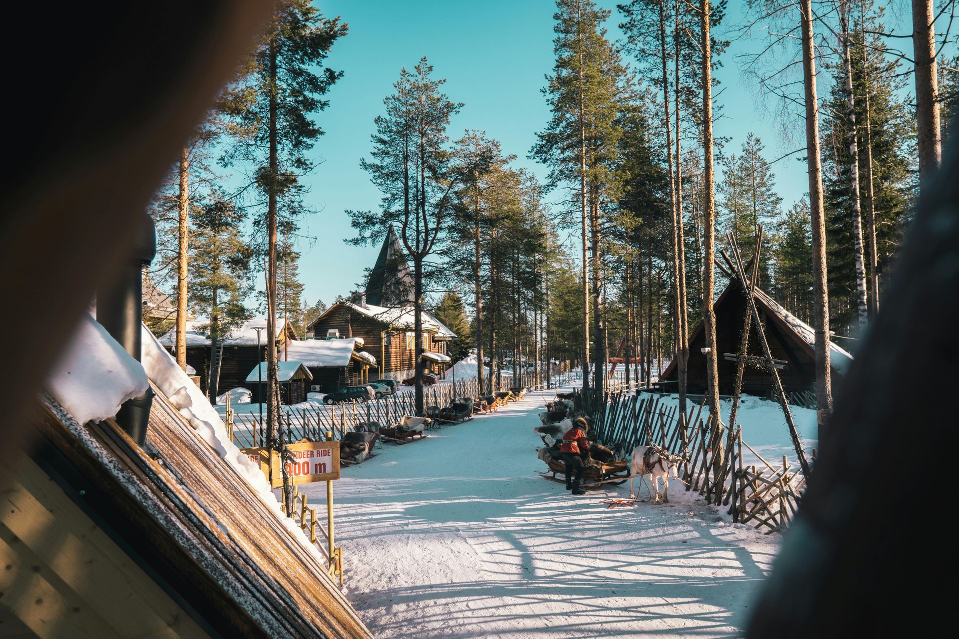 A person is looking out of a car window at a snowy forest in Finland.