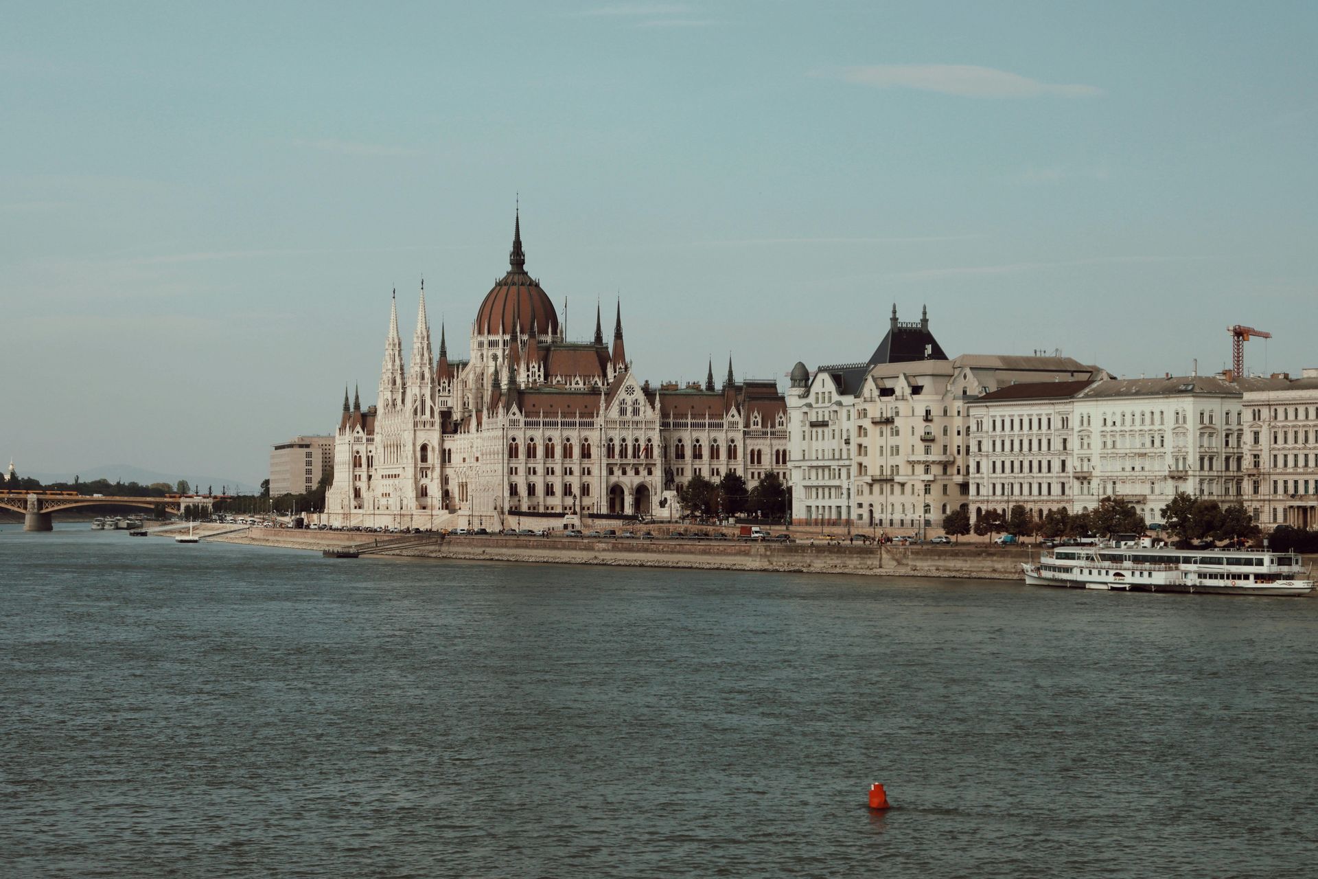 A large building is sitting on the shore of The Danube River.