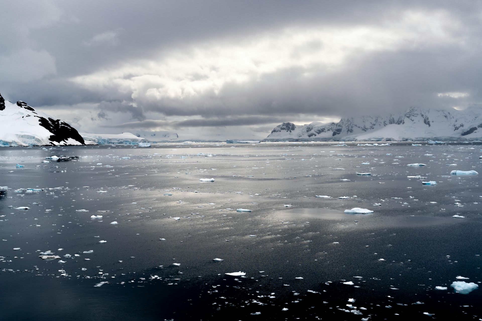 A large body of water with mountains in the background  in Antarctica.