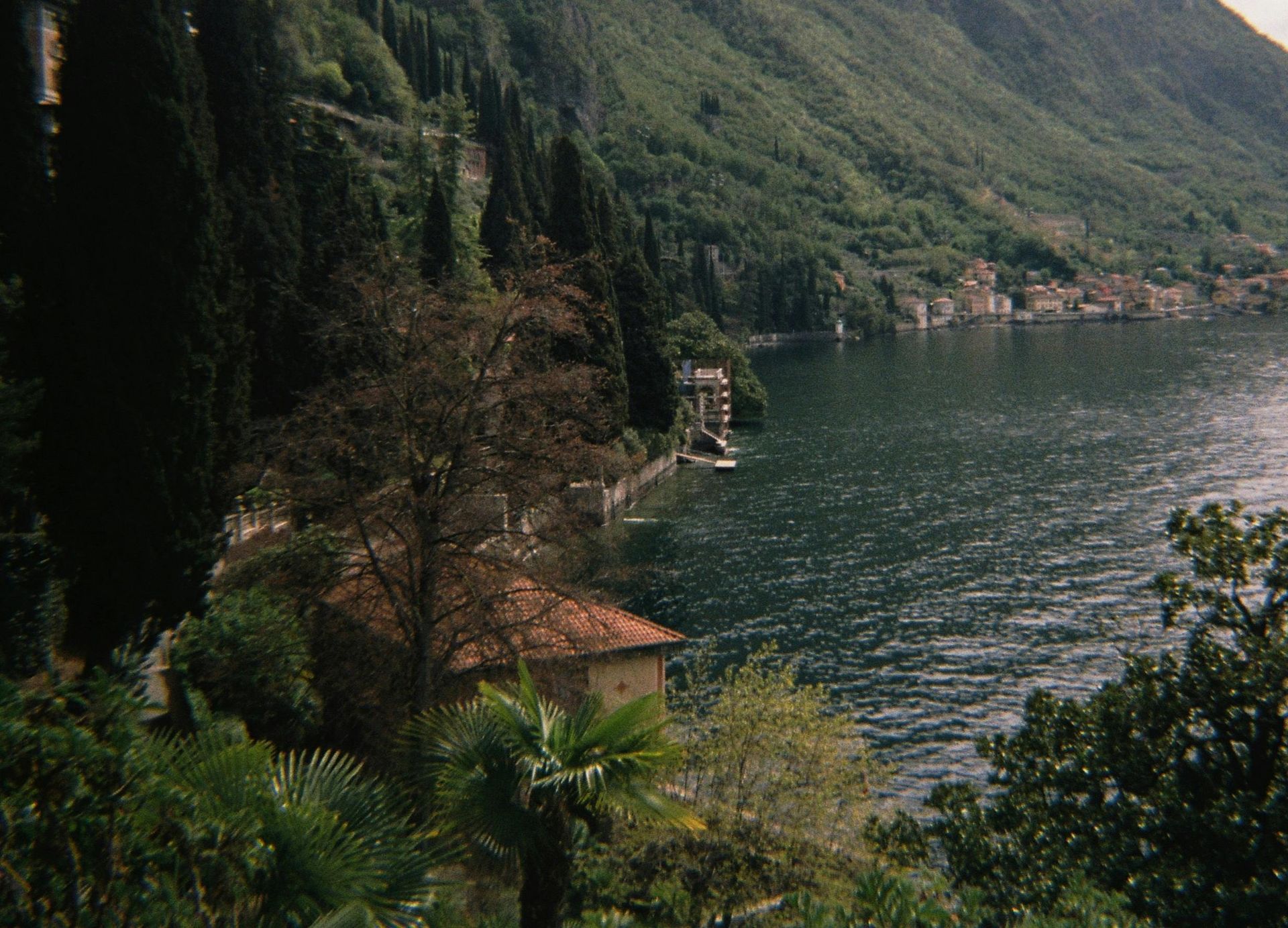 Lake Como surrounded by mountains and trees in Italy.