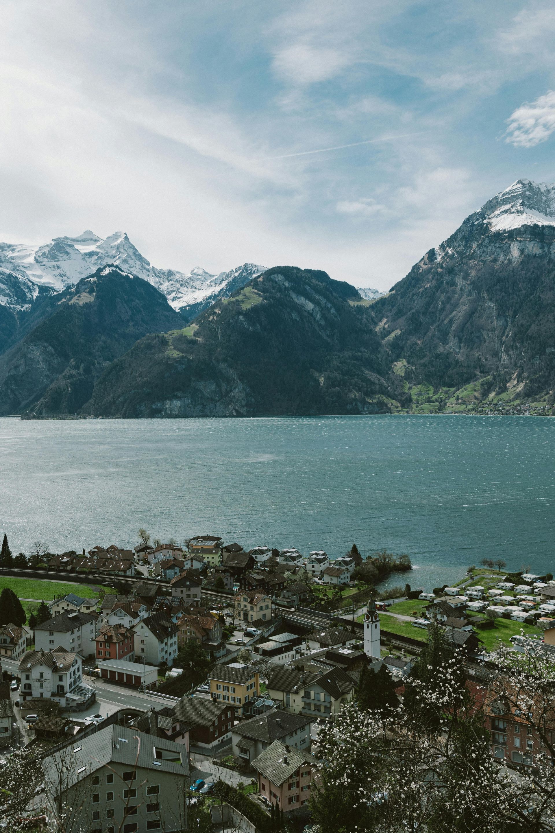 A lake with mountains in the background and a city in the foreground in Switzerland.