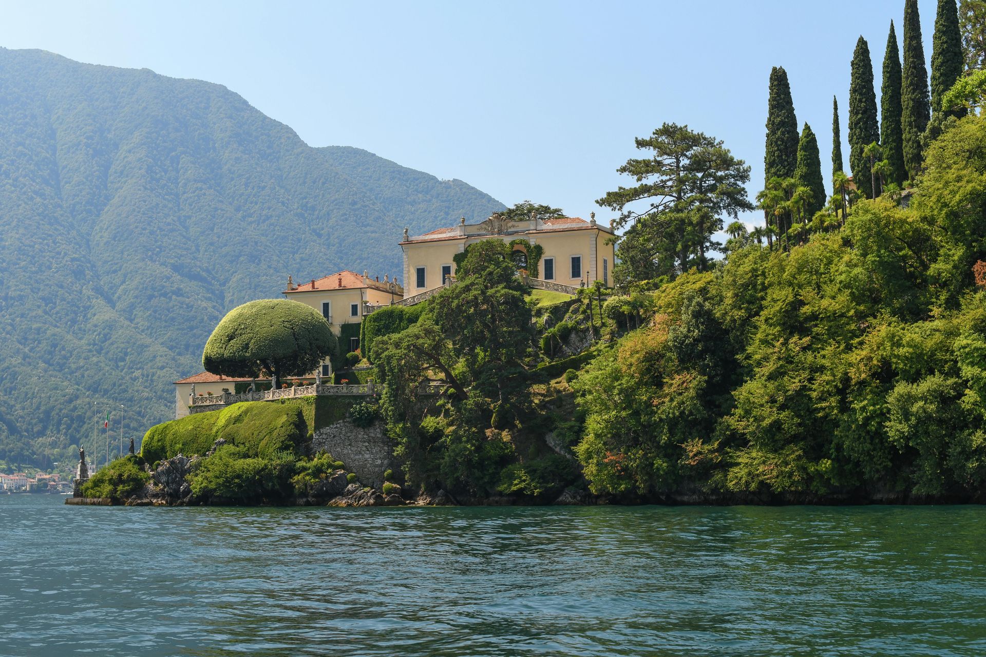 A large house sits on a small island in the middle of Lake Como in Italy.