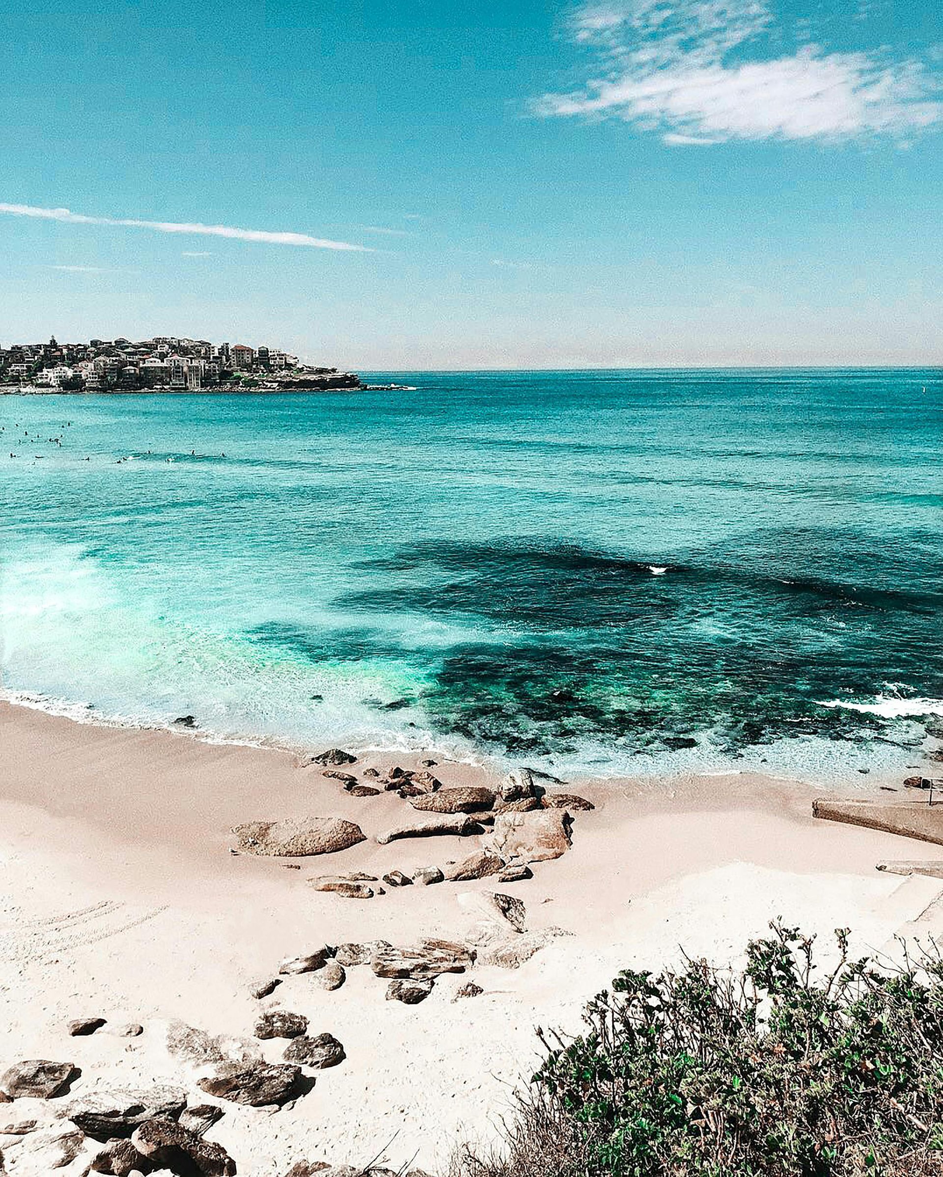 A beach with a large body of water in the background in Australia.