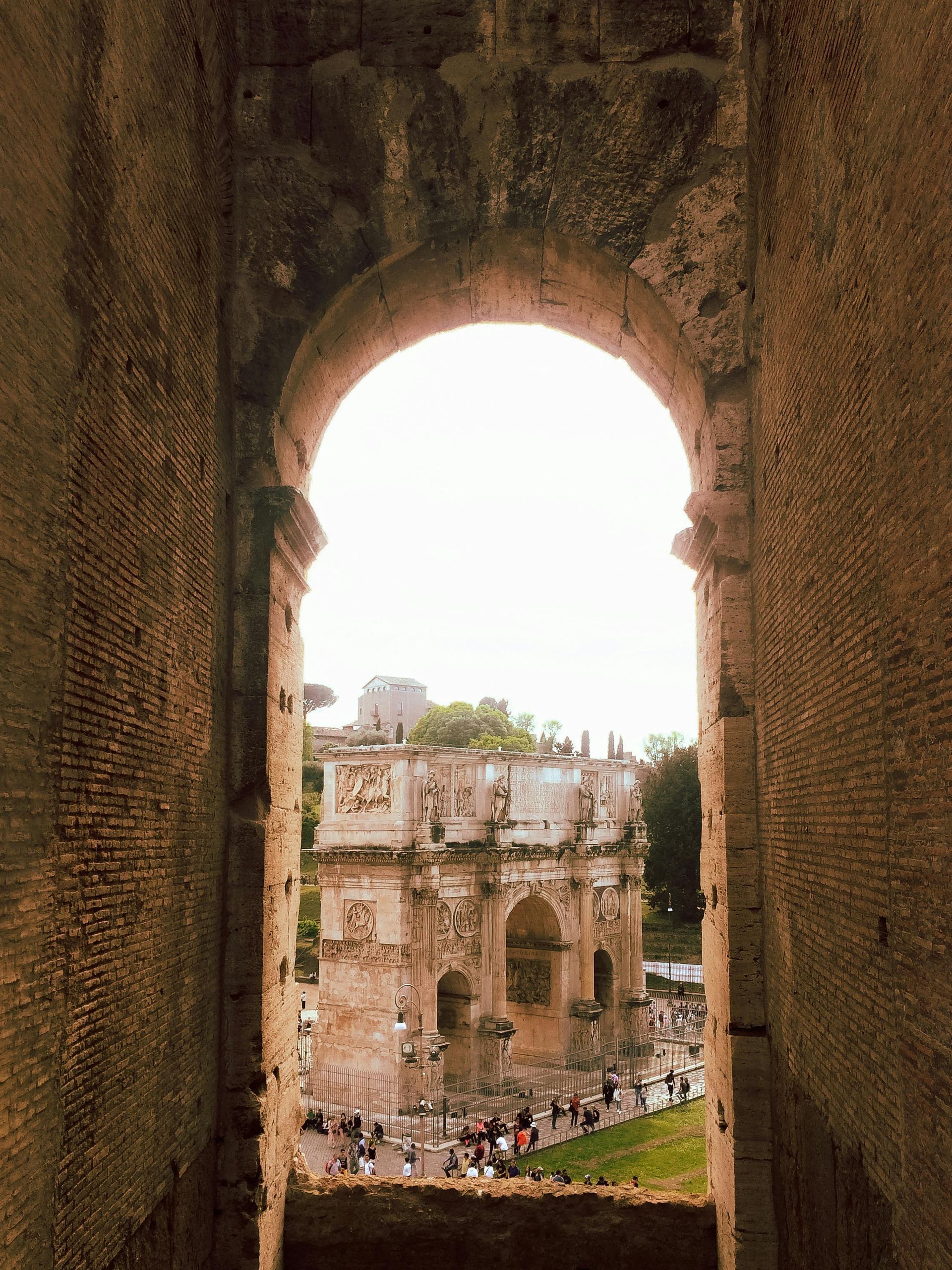 A view of a building through a stone archway in Rome, Italy.