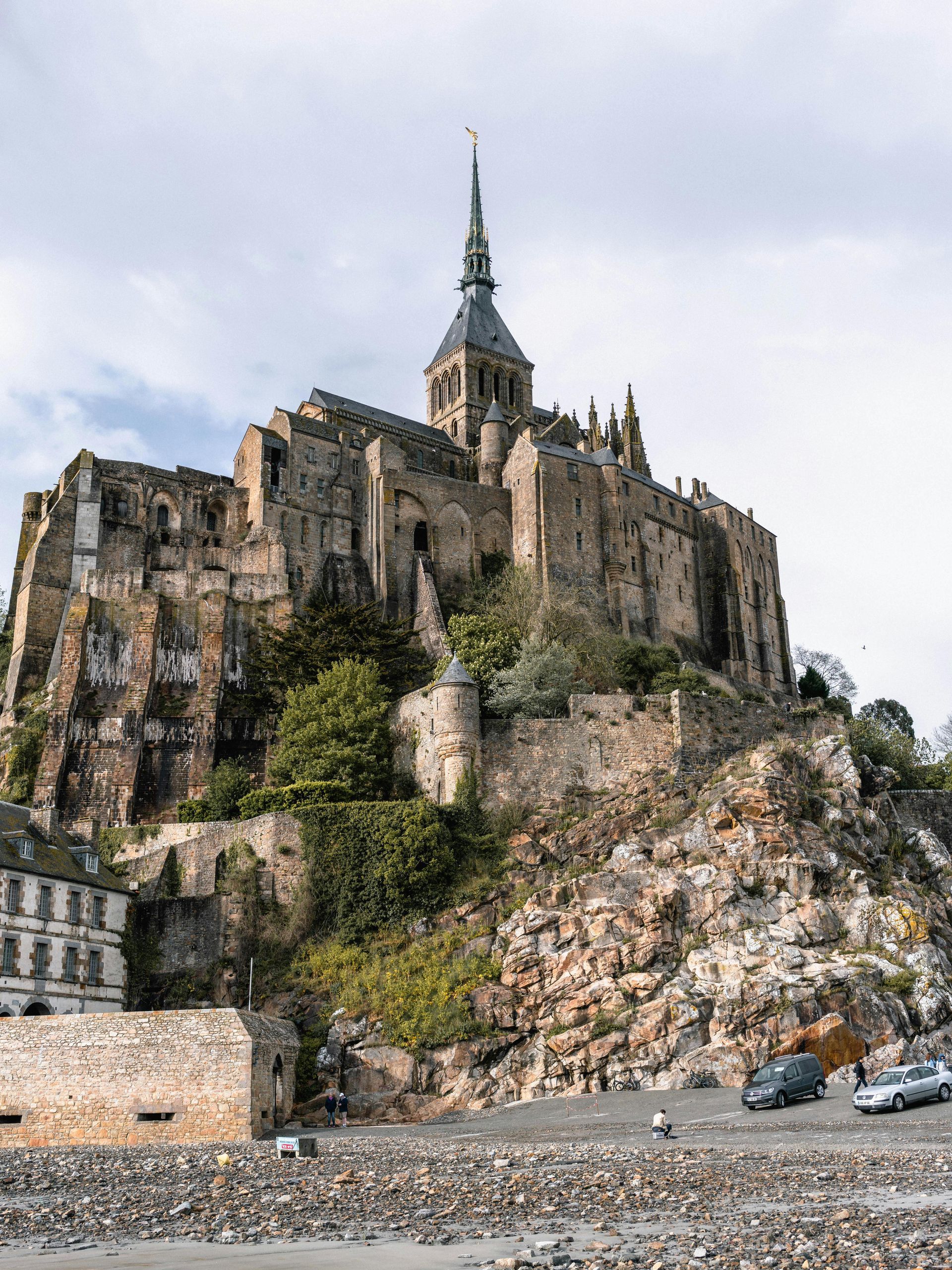 The large castle Mont Saint-Michel is sitting on top of a rocky hill in Normandy, France.