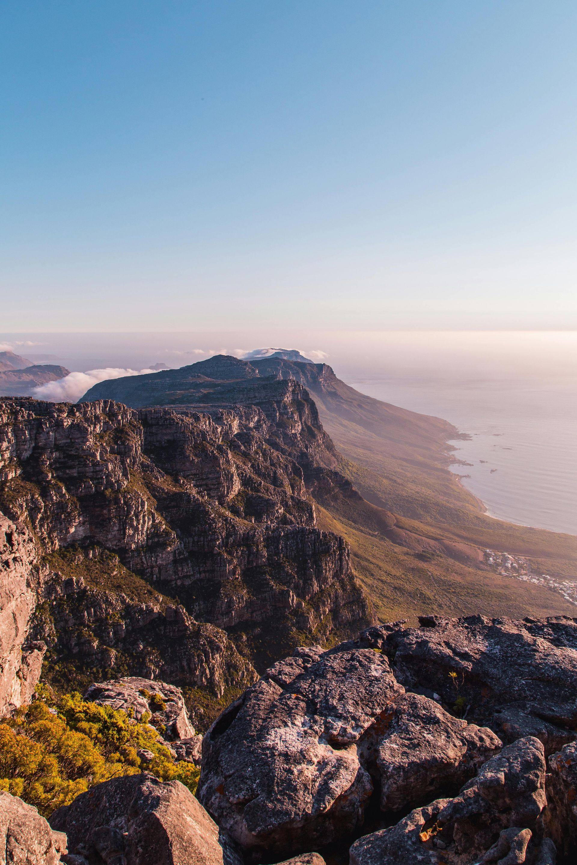 A view of a mountain range with a body of water in the background in South Africa.