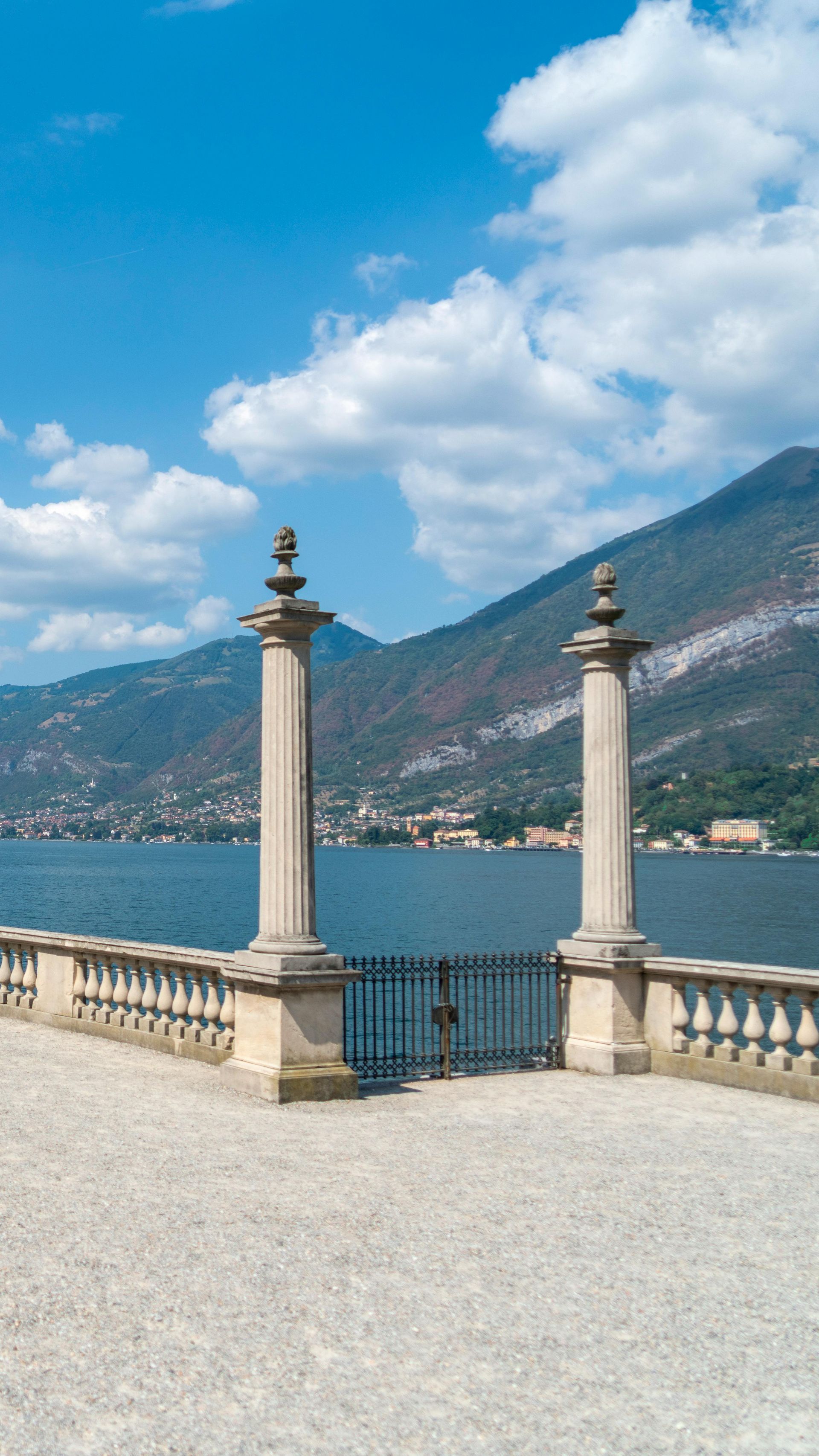 A balcony overlooking Lake Como with mountains in the background in Italy.