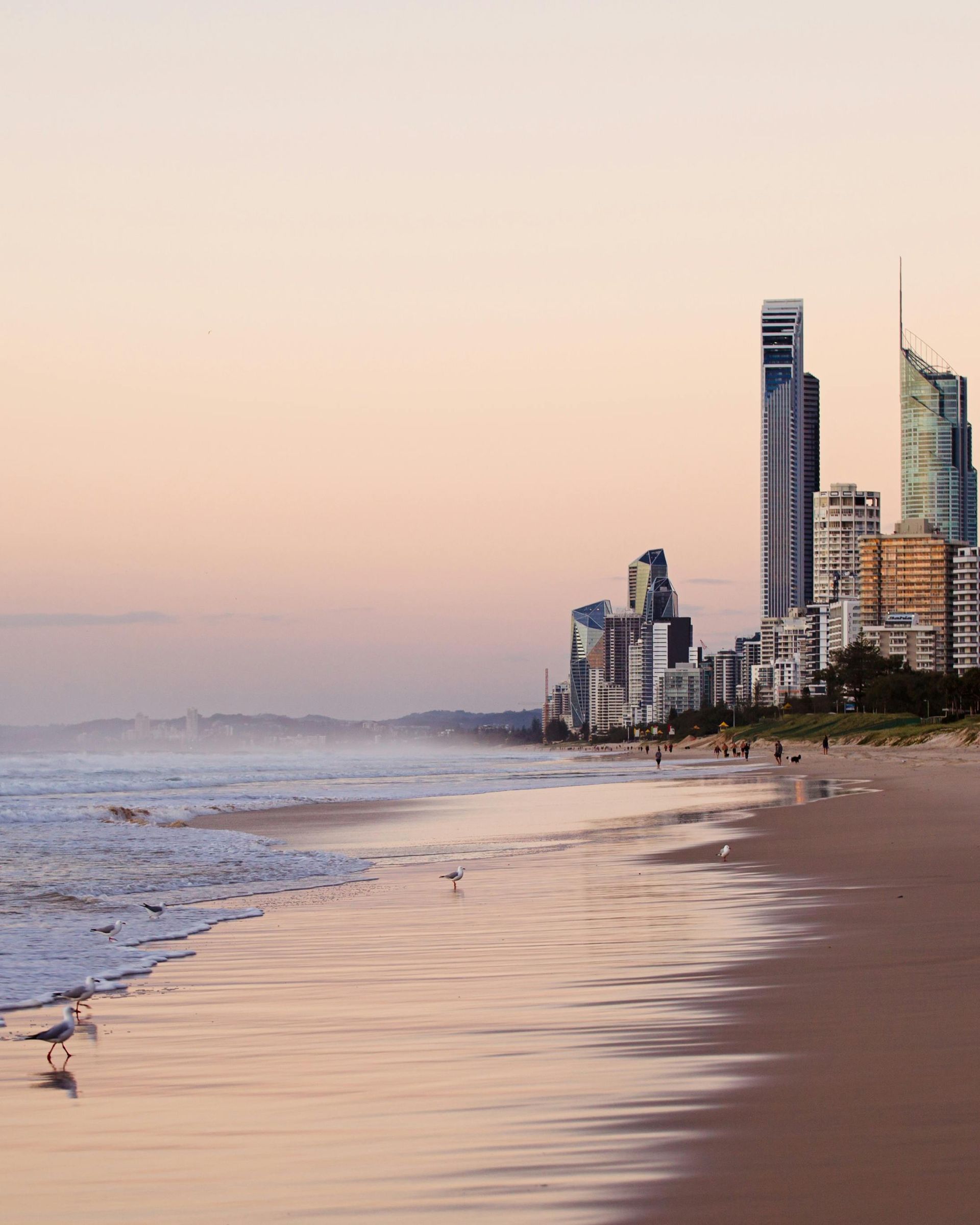 A beach with a city skyline in the background in Australia.