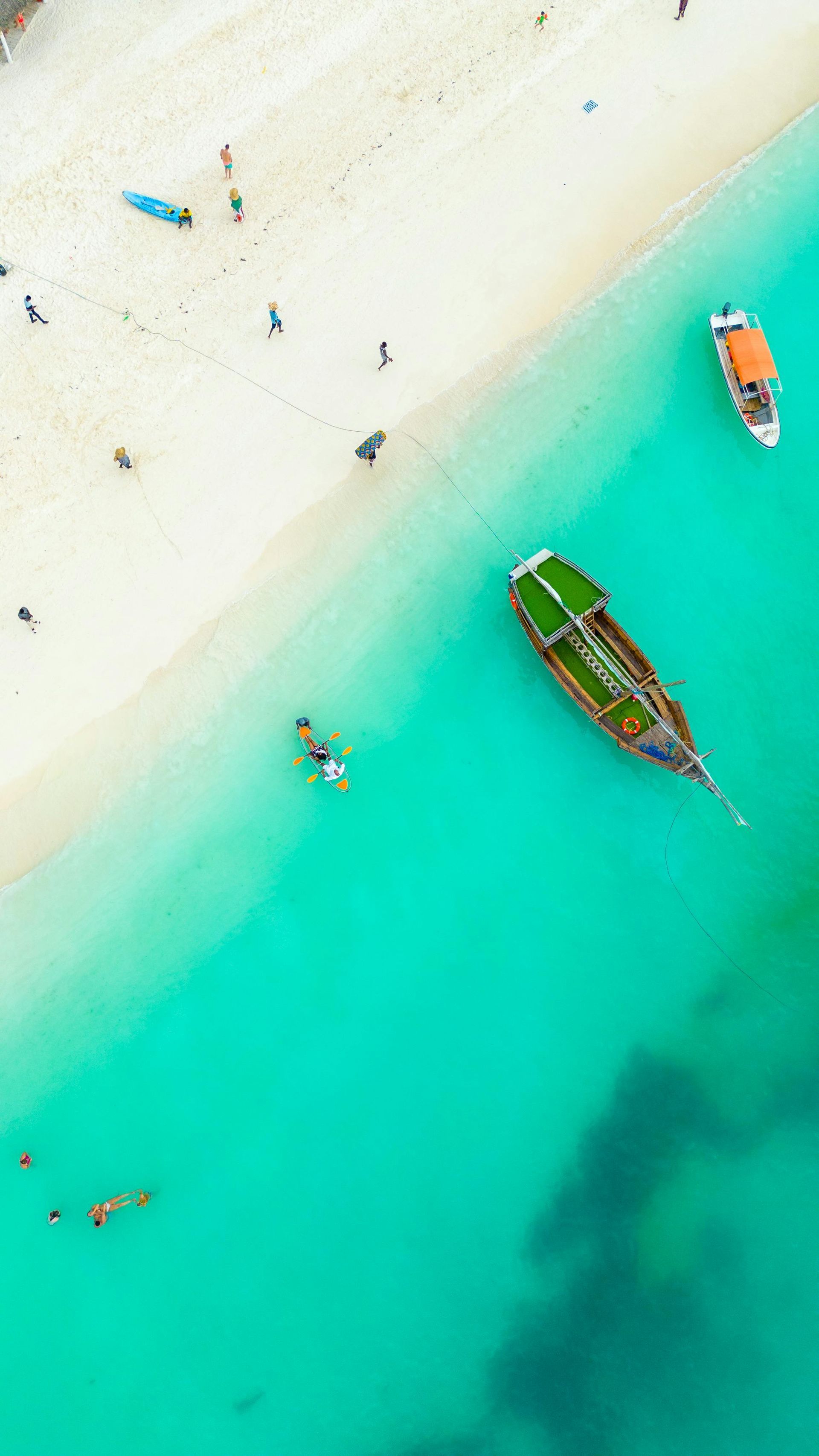 An aerial view of a beach with boats in the water on Zanzibar island in Tanzania, Africa.