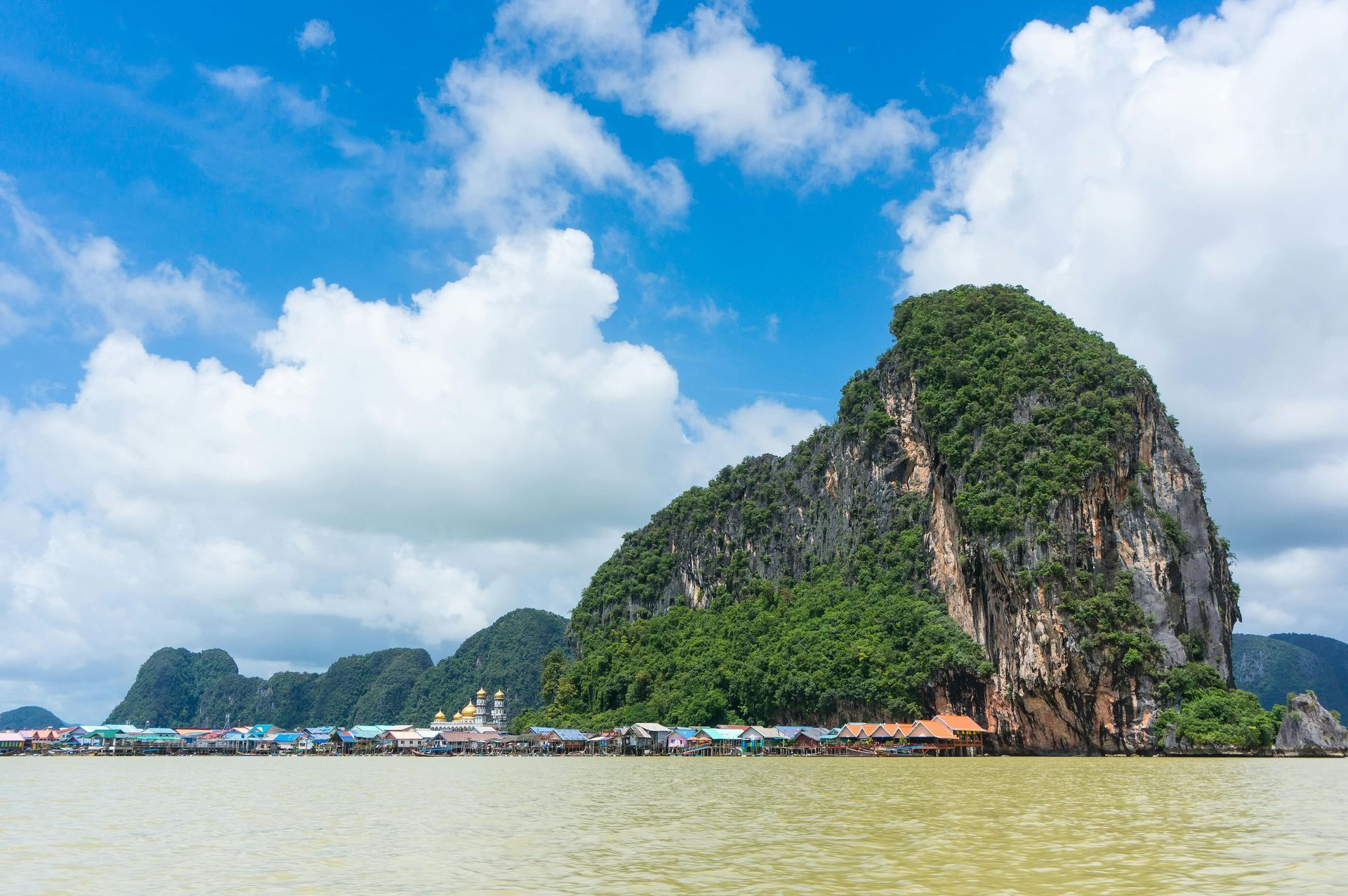 A large rocky island in the middle of a body of water in Thailand.